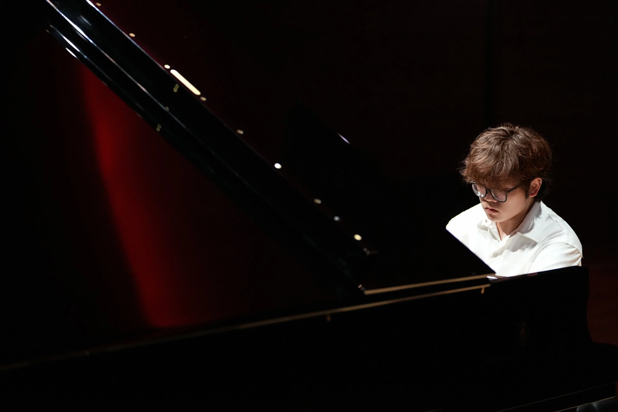 Hao Rao, pianist, performing on grand piano during a concert recital.