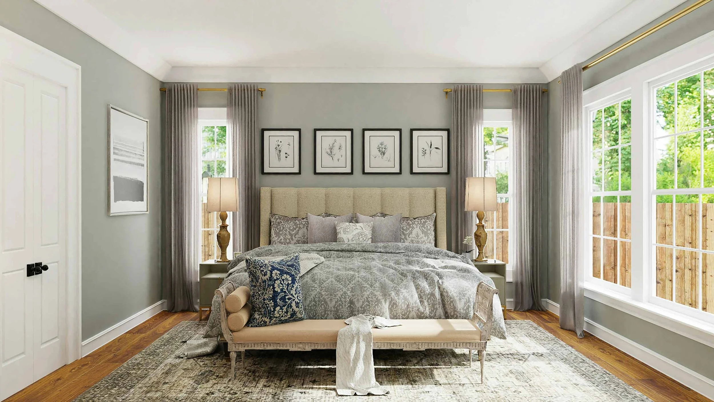Bright bedroom with large windows, grey curtains, a beige upholstered headboard, framed botanical prints, two table lamps, a bench at the foot of the bed, decorative pillows, a patterned blanket, and a rug on hardwood flooring.
