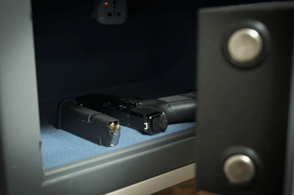 Handgun and magazine inside a security safe.