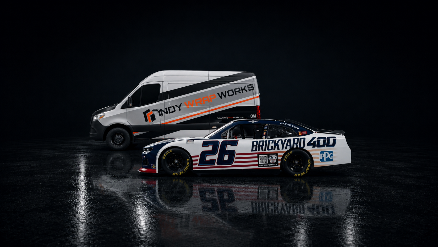 A race car with the number 26 and branding for Brickyard 400 parked on a wet surface, positioned in front of a white van with branding for Andy Wrap Works, against a dark background.
