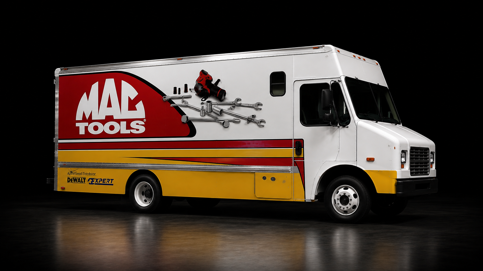 A Mac Tools service truck with a white, red, and yellow color scheme, displaying various tools on its side, parked on a reflective surface against a black background.