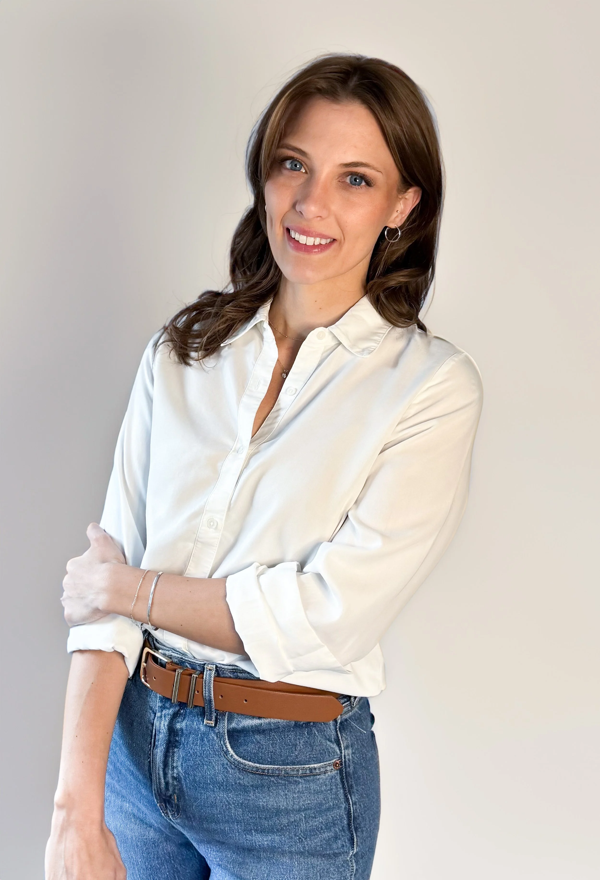 Bree Newbrough, founder and wedding planner at Bloom Events in Northern Nevada, smiling in a white blouse against a neutral background.