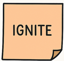 A sticky note with the word 'IGNITE' written in bold black letters on a peach-colored background.