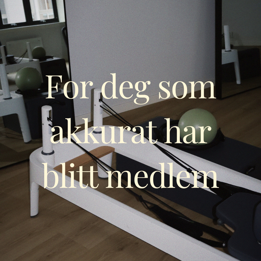 A Pilates reformer machine with a green exercise ball in a fitness studio.