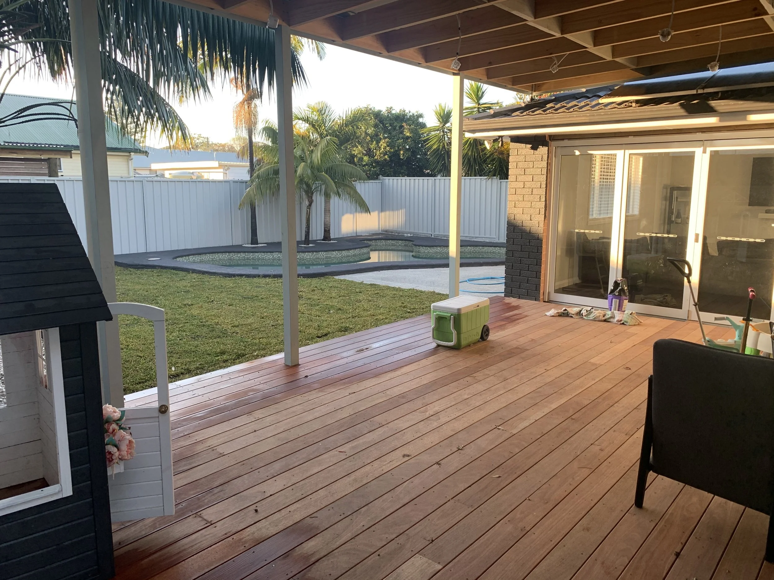 AFTER: Tree removal, pool refinishing, paving, turf installation, deck and pergola construction, garden beds, stacking door installation, external painting