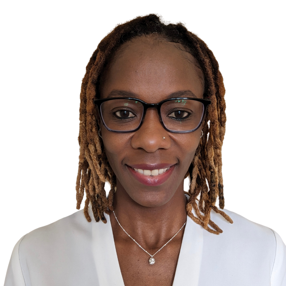 A woman with reddish-brown dreadlocks, wearing glasses, a pearl necklace, and a white top, smiling against a white background.