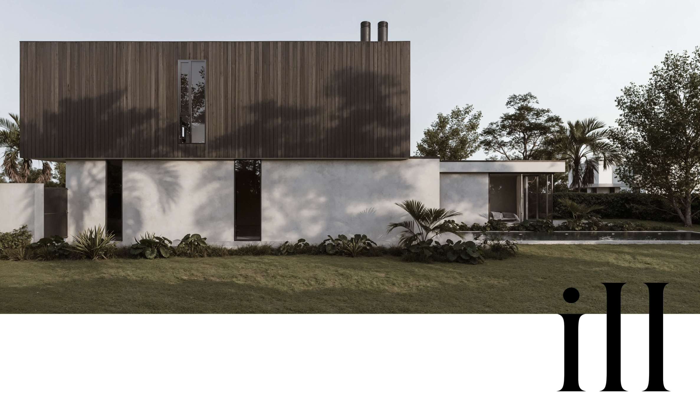 Modern two-story house with a wood-paneled upper level, concrete lower level, surrounded by greenery and trees, with a lawn in the foreground.