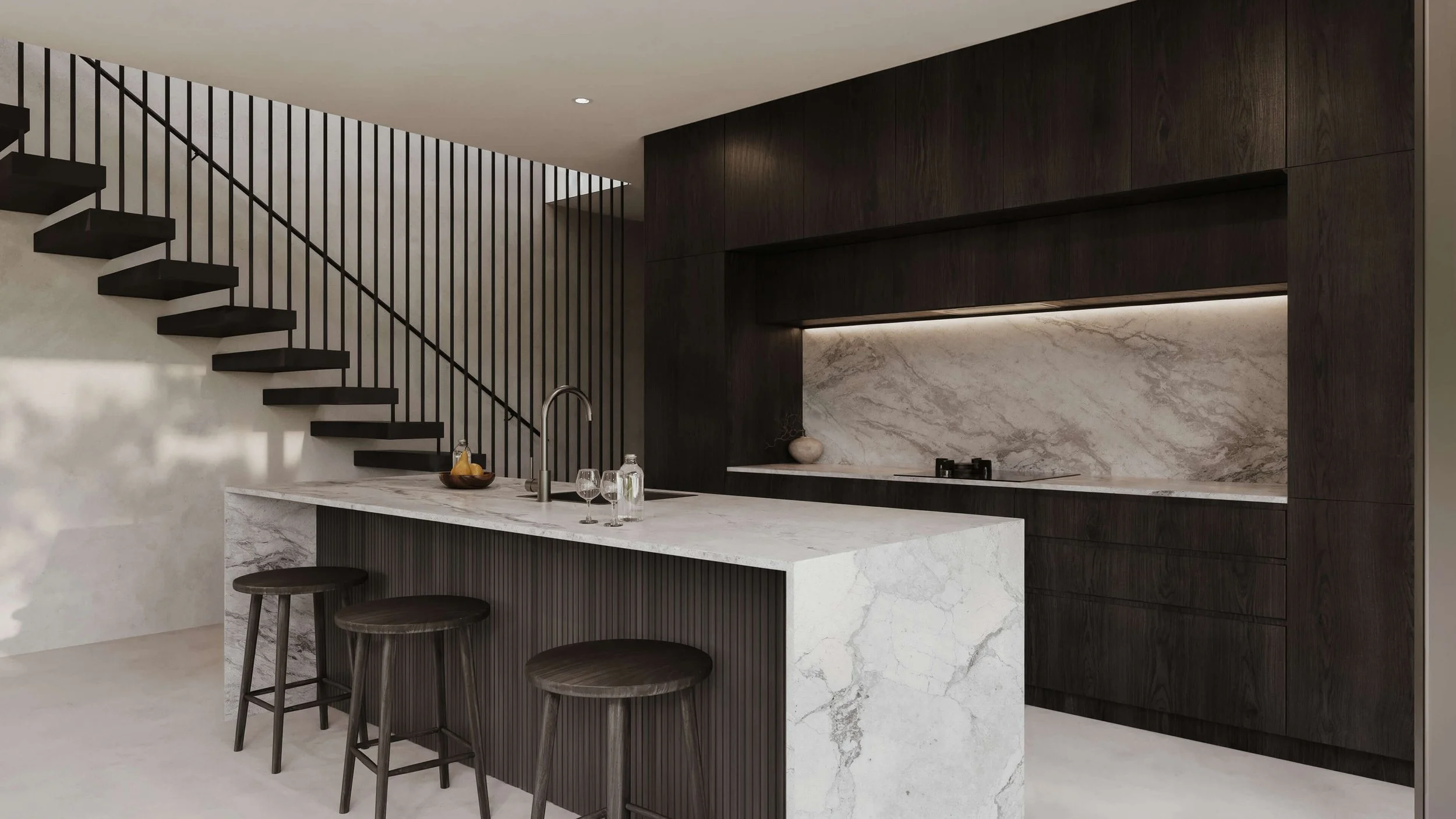 Modern kitchen with dark wood cabinets, marble backsplash and island, and black bar stools, adjacent to a staircase.