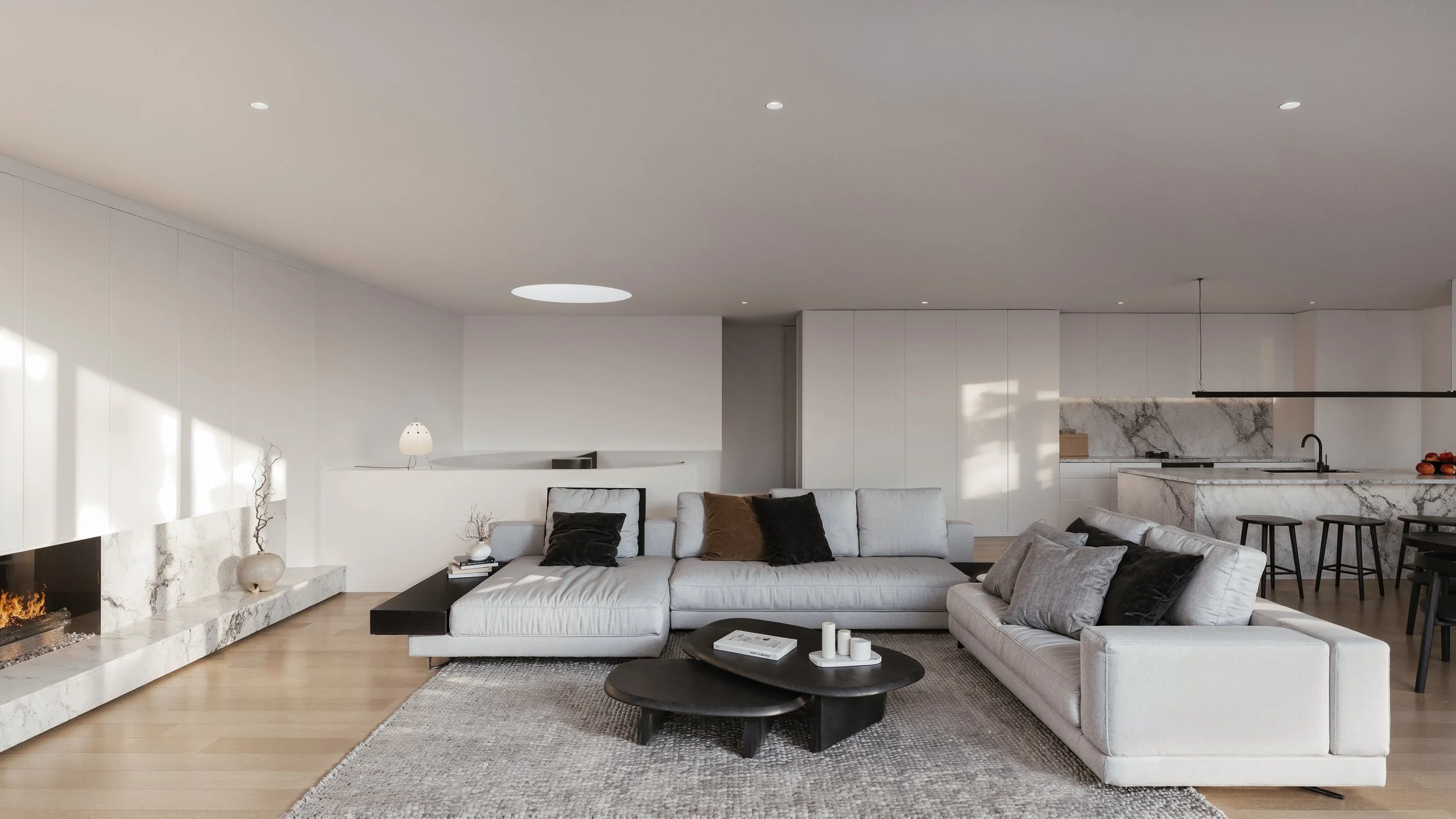 Modern living room with white sofa, black coffee table, and marble kitchen in background.