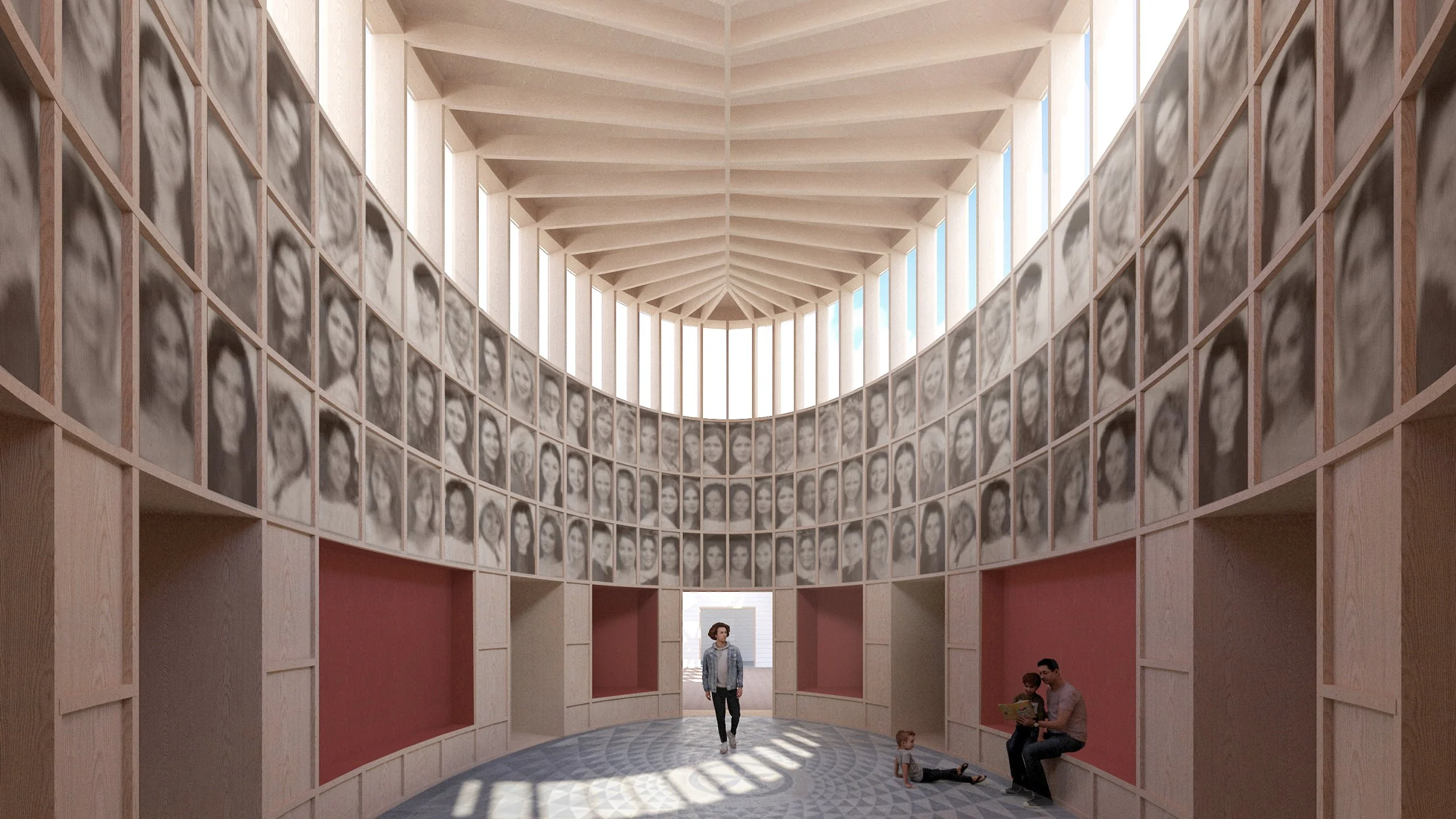 Interior of a modern building with a curved wall featuring numerous black-and-white portrait photographs arranged in a semi-circle. The space is illuminated by natural light from tall windows above. A woman walking through, a man and child sitting on