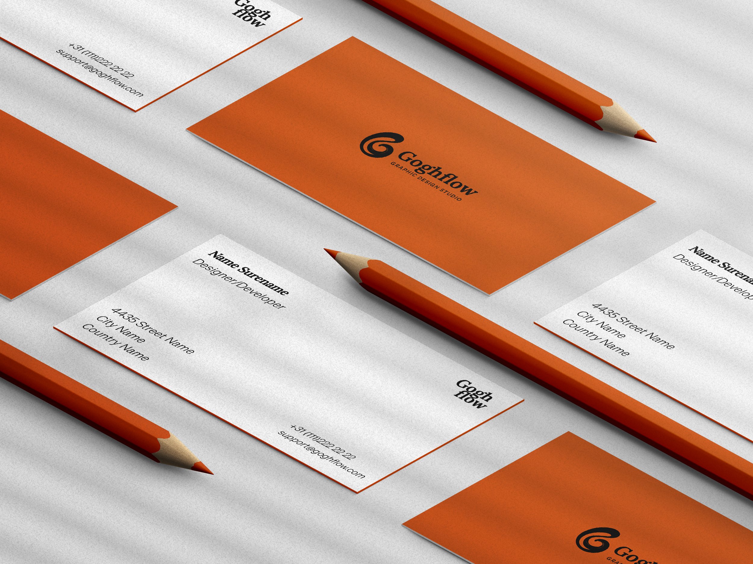 Business cards and pencils with a white background for a graphic design studio named 'GoohFlow' with orange and white color scheme.