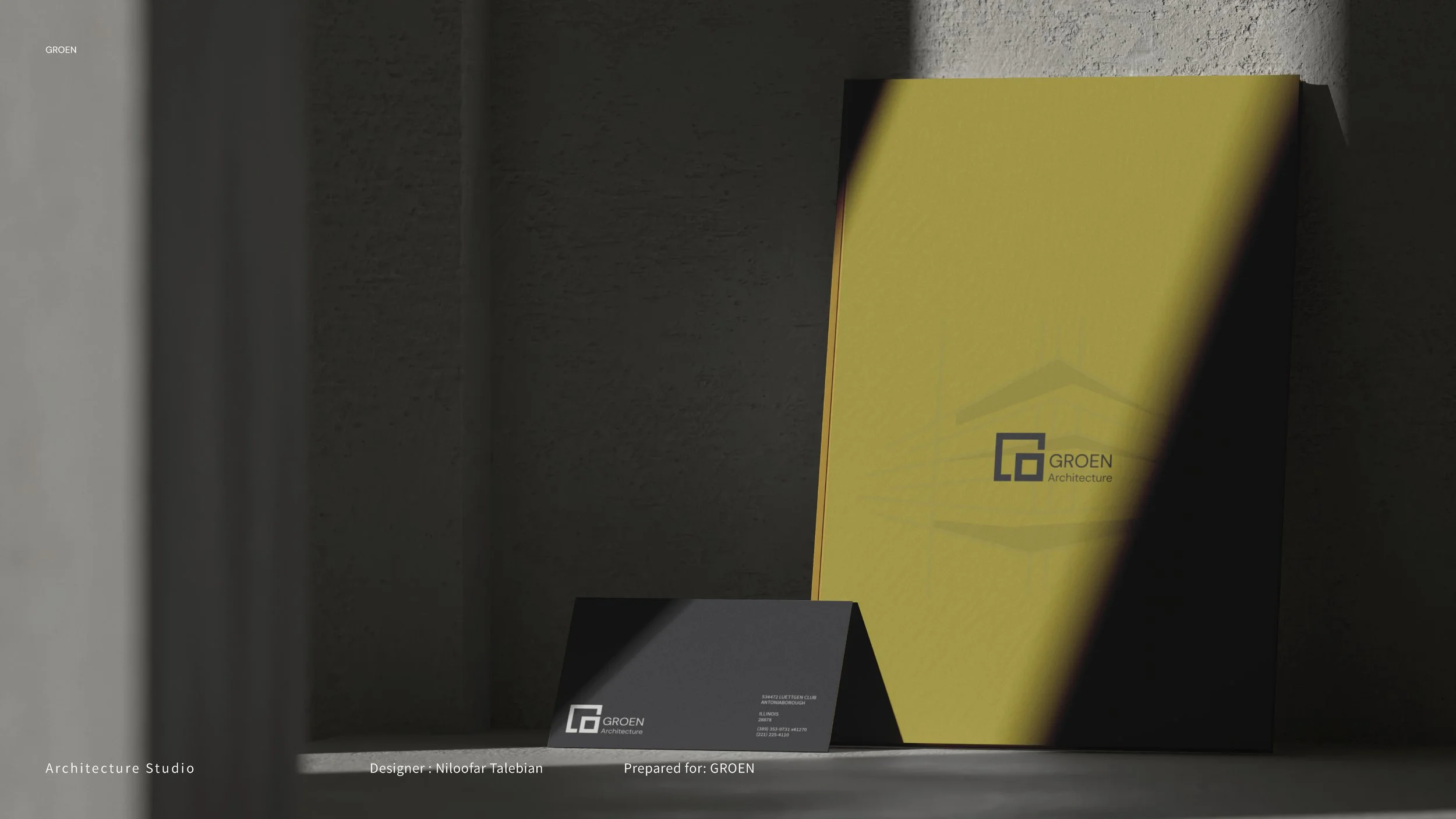 An architectural presentation display with a large yellow and black vertical panel and a black card with white and gray text, including the logo of Groen Architecture, on a shelf with a gray wall background.