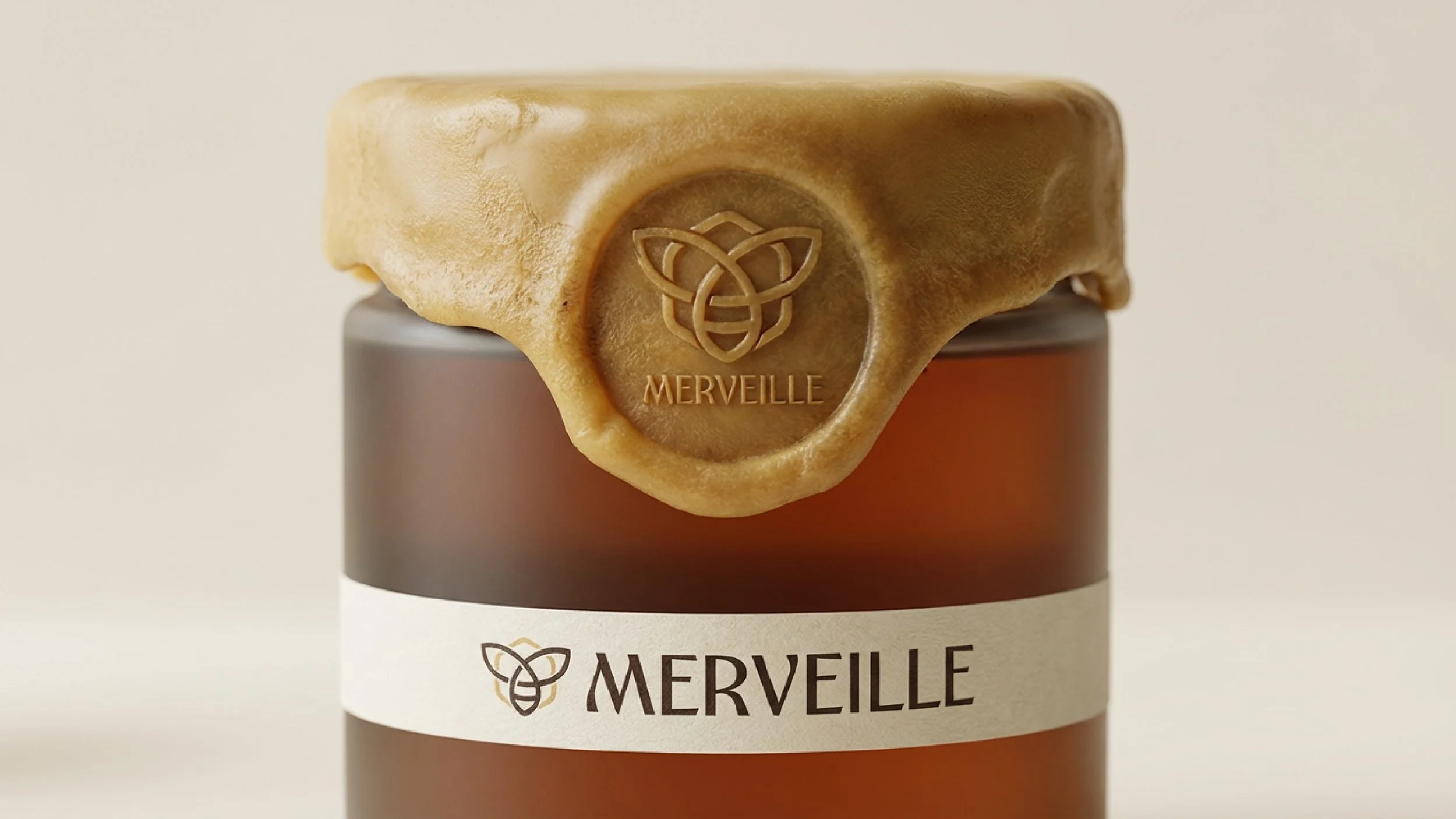 A glass jar with a brown lid, wrapped with a cream-colored label featuring the brand name 'MERVEILLE' and a logo of a bee. A wax seal with the 'MERVEILLE' logo is attached to a golden-brown wax lid placed on top of the jar.