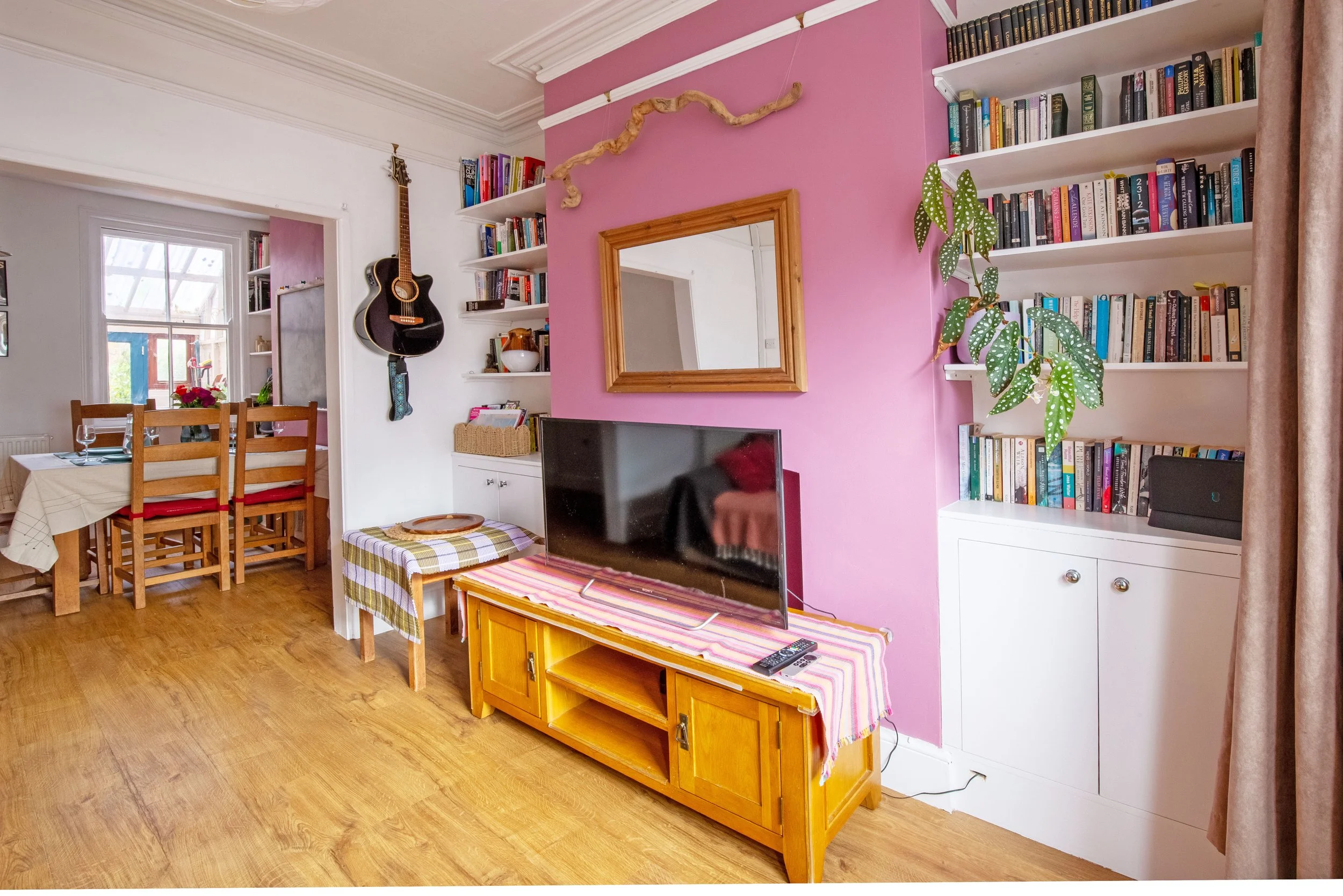 Living room and bookshelves. There is a fair range of books from literature, popular science and history, art related, cycling, climbing. Turn the tv on or read a book? Maybe read a book, scroll on your phone and watch the tv.