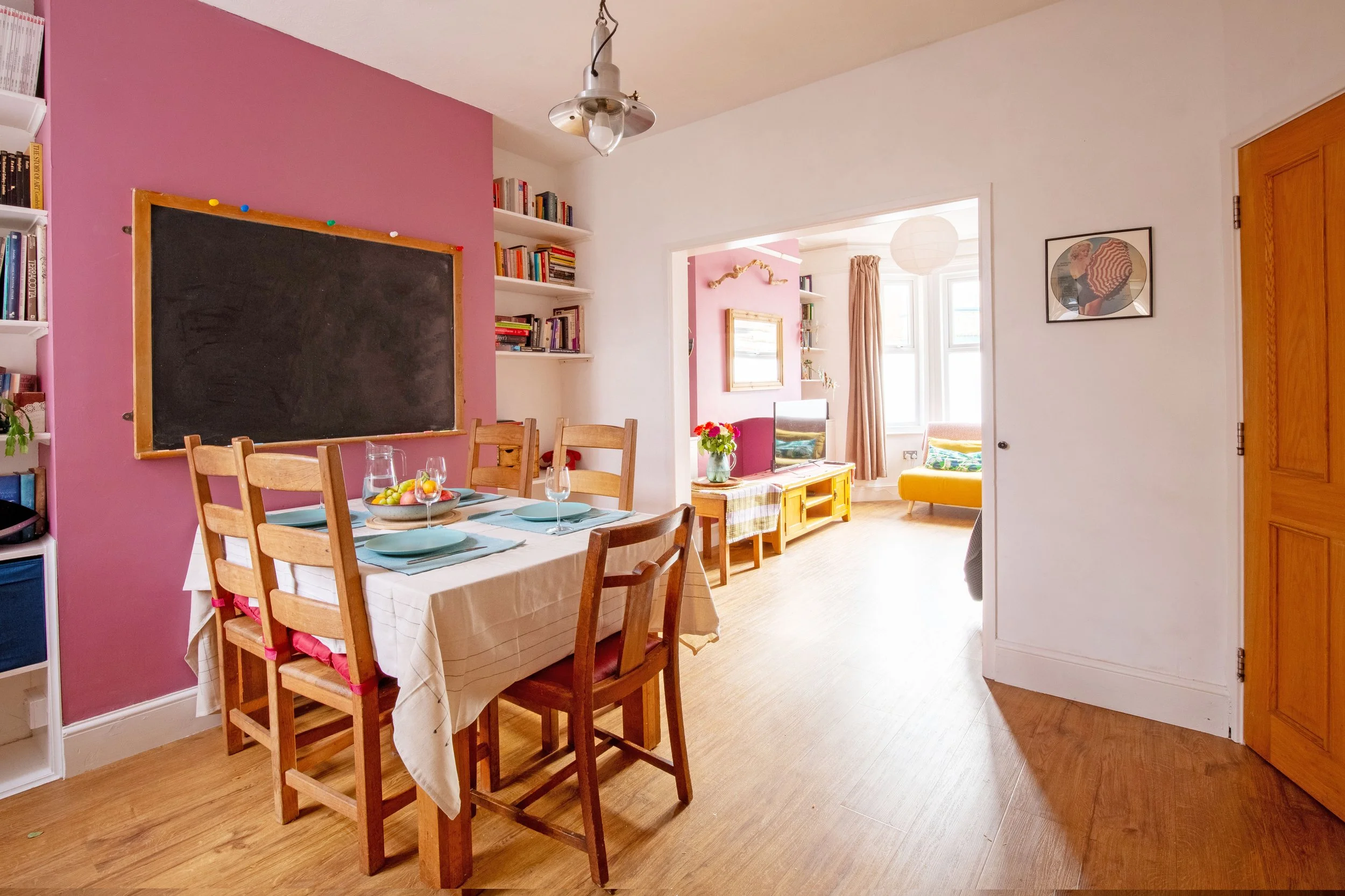 Dining room looking towards living room with a Marilyn Monroe record on the wall.