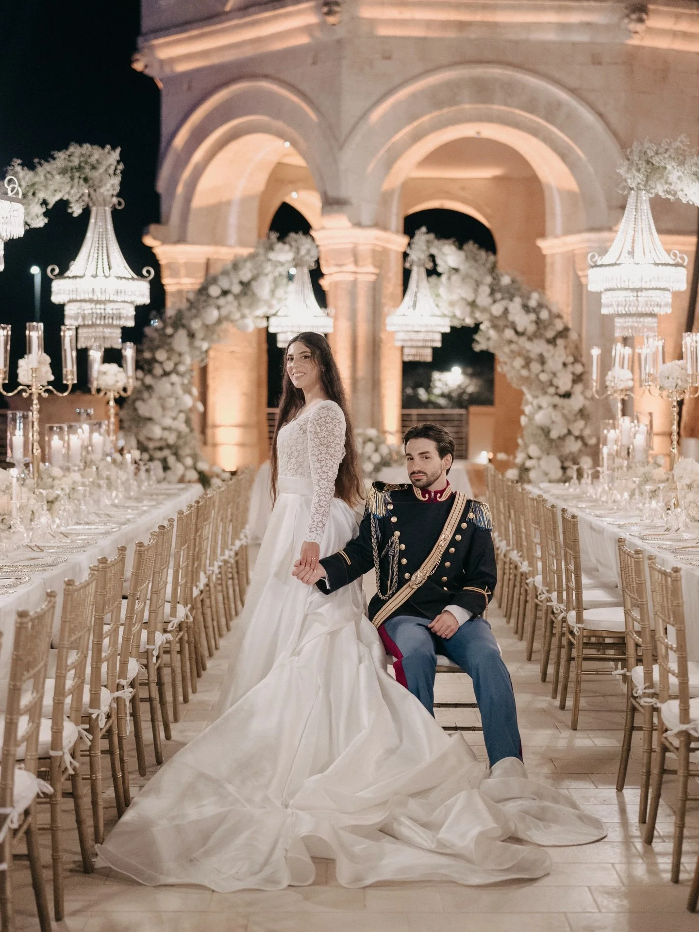 Under the warm lights of Castello Tafuri, Naomi and Fabio celebrated a love that felt both timeless and intimate.

A long imperial table, crystal chandeliers suspended in the night air, and a floral arch embracing the moment they chose each other for