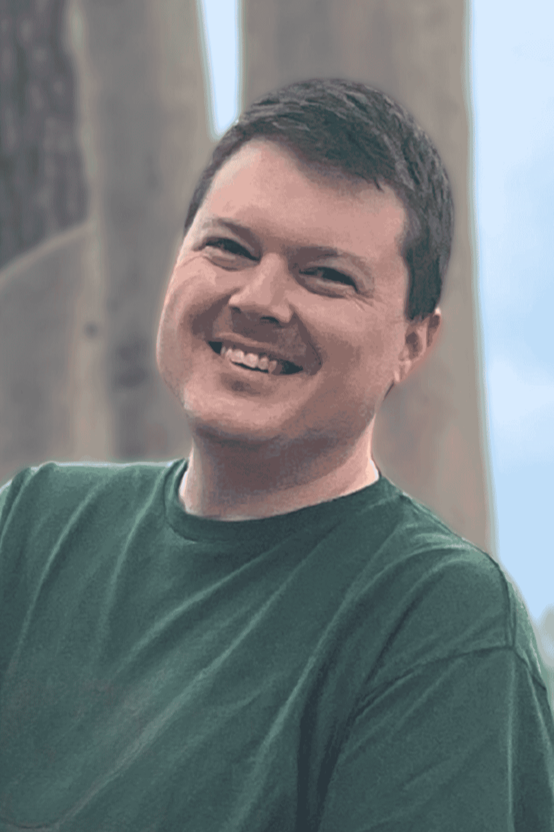 Co-Founder Matt Barham wears a green shirt and smiles at the camera  - Merry Berry Confection Co, a micro-bakery specializing in holiday bakes and dessert bars for weddings and events near Raleigh, NC