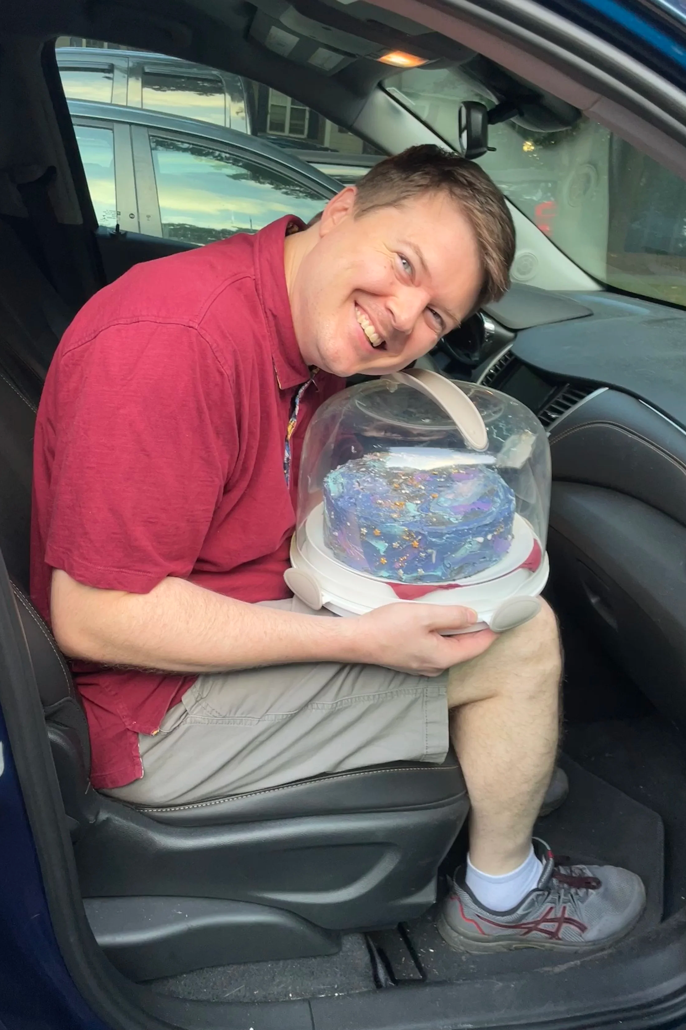 Merry Berry Co-Founder Matthew Barham shows off the Galactic Cake in its carrier - Merry Berry Confection Co, a micro-bakery specializing in holiday bakes and dessert bars for weddings and events near Raleigh, NC