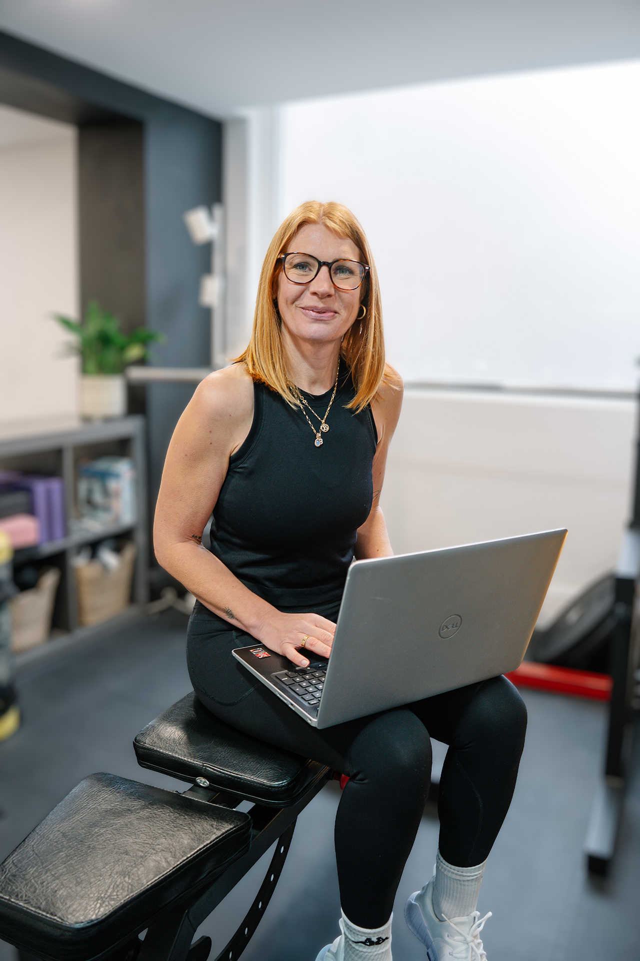 Online personal trainer Ruby Tuttlebee creating personalised training programmes on her laptop