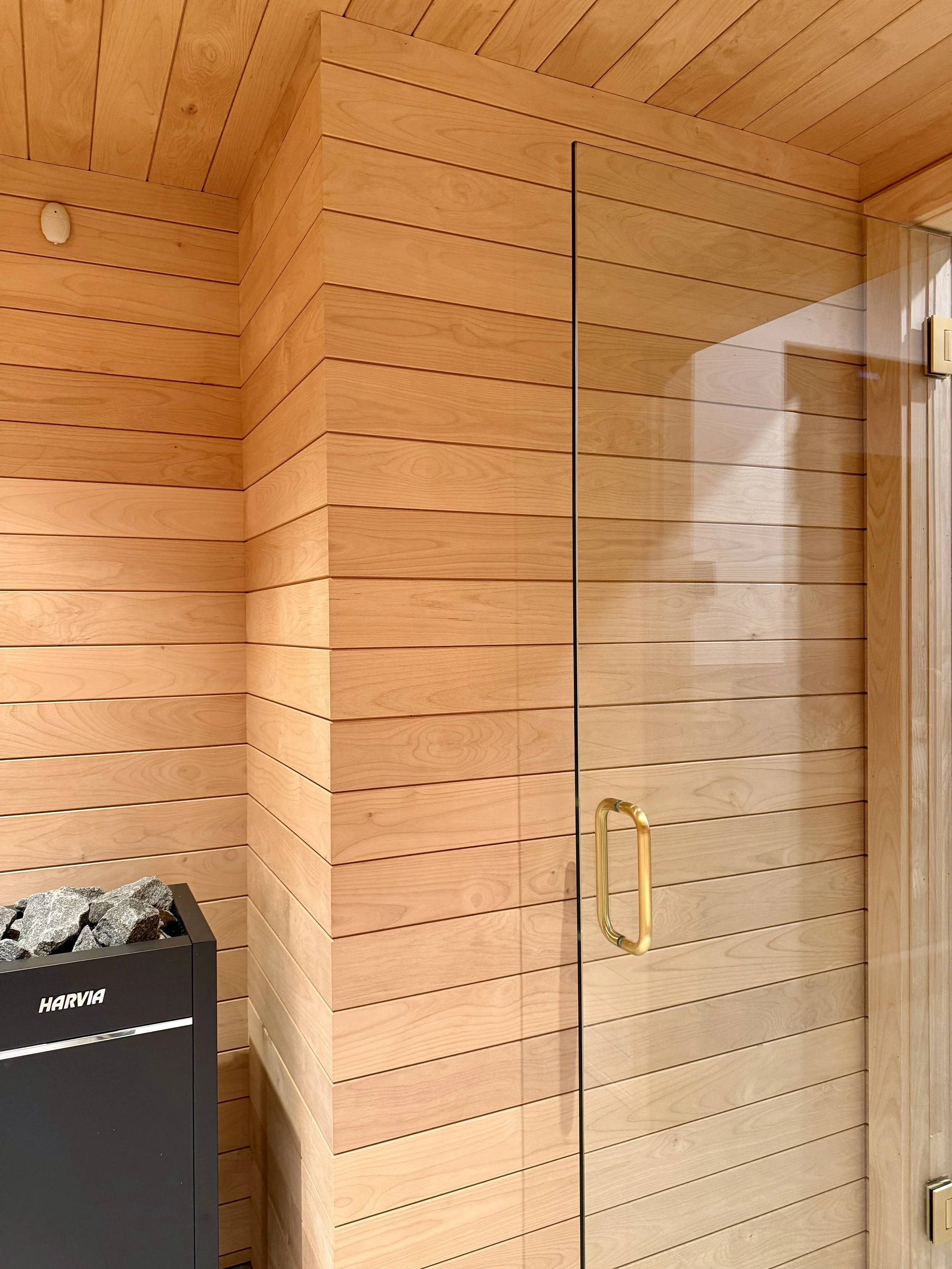 Architectural Details of Custom Built Sauna Using 3/4" X 4" Milled Tongue & Groove Alder Hardwood and Linear Benches Reinforced with Steel. 

Under-mount Bench Lighting and Recessed Ceiling Lights Painted to Match.

Custom Sauna Door in 1/2" Clear Gl