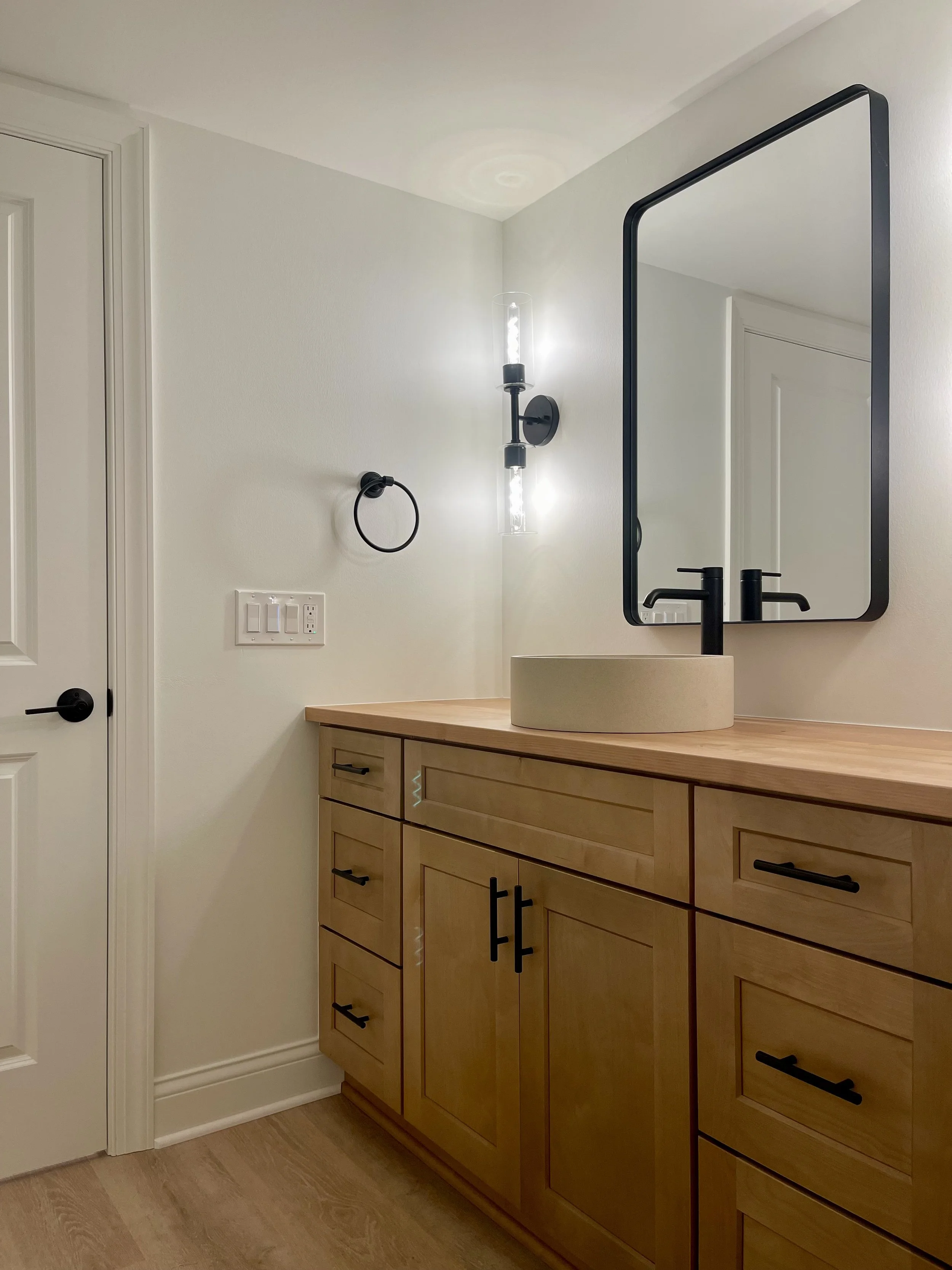 Architectural Details of Custom Built Bathroom Vanity Base Cabinet in White Oak with Matte Black Hardware and Solid Alder Top. 

Plumbing Fixtures are Kohler. 

Scandinavian Inspired Remodeling Project Completed in Northville MI. 