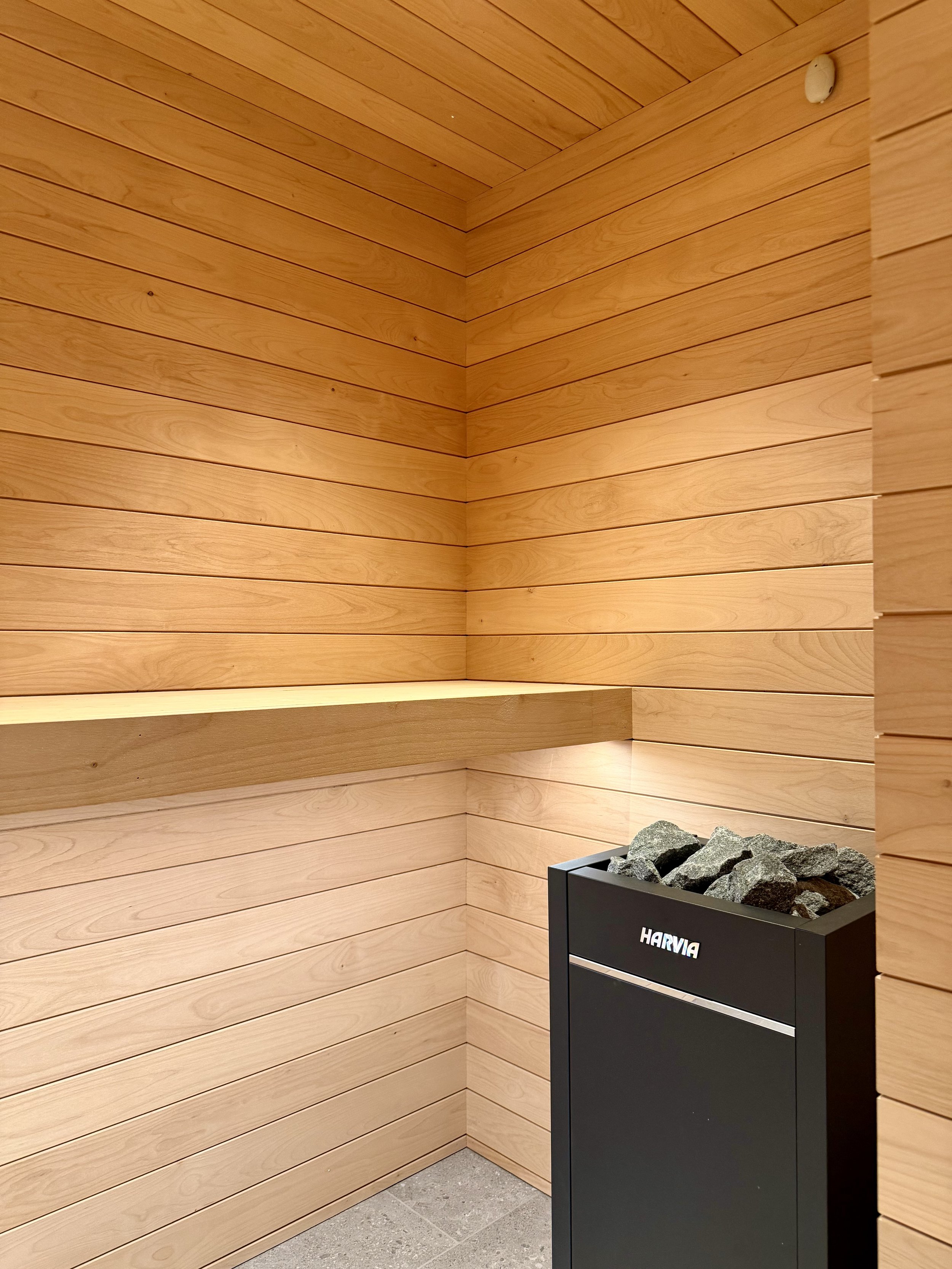 Architectural Details of Custom Built Sauna Using 3/4" X 4" Milled Tongue & Groove Alder Hardwood and Linear Benches Reinforced with Steel. 

Under-mount Bench Lighting and Recessed Ceiling Lights Painted to Match.

Custom Sauna Door in 1/2" Clear Gl