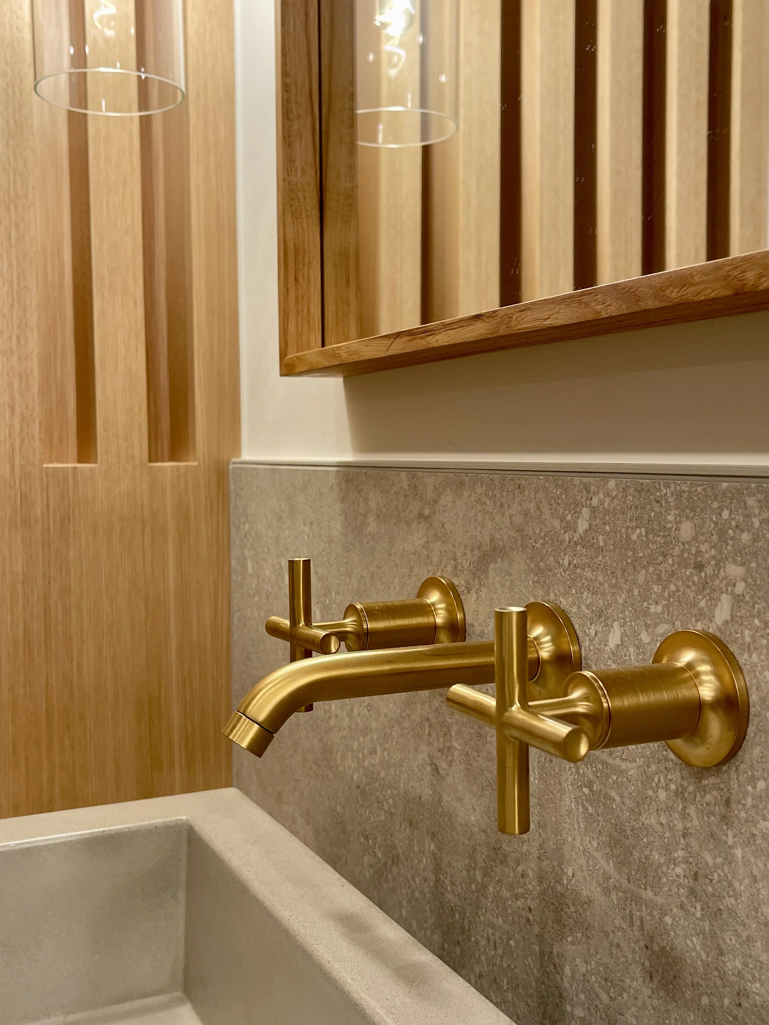 Architectural Detail in Uniform Hickory Veneer and Hickory Heartwood Finished with Centurion 2K Polyurethane.

Wall Mounted Plumbing Fixture is Kohler Purist in Vibrant Brushed Modern Gold. 

TrueForm Custom Concrete Sink in Taupe

Scandinavian Inspi