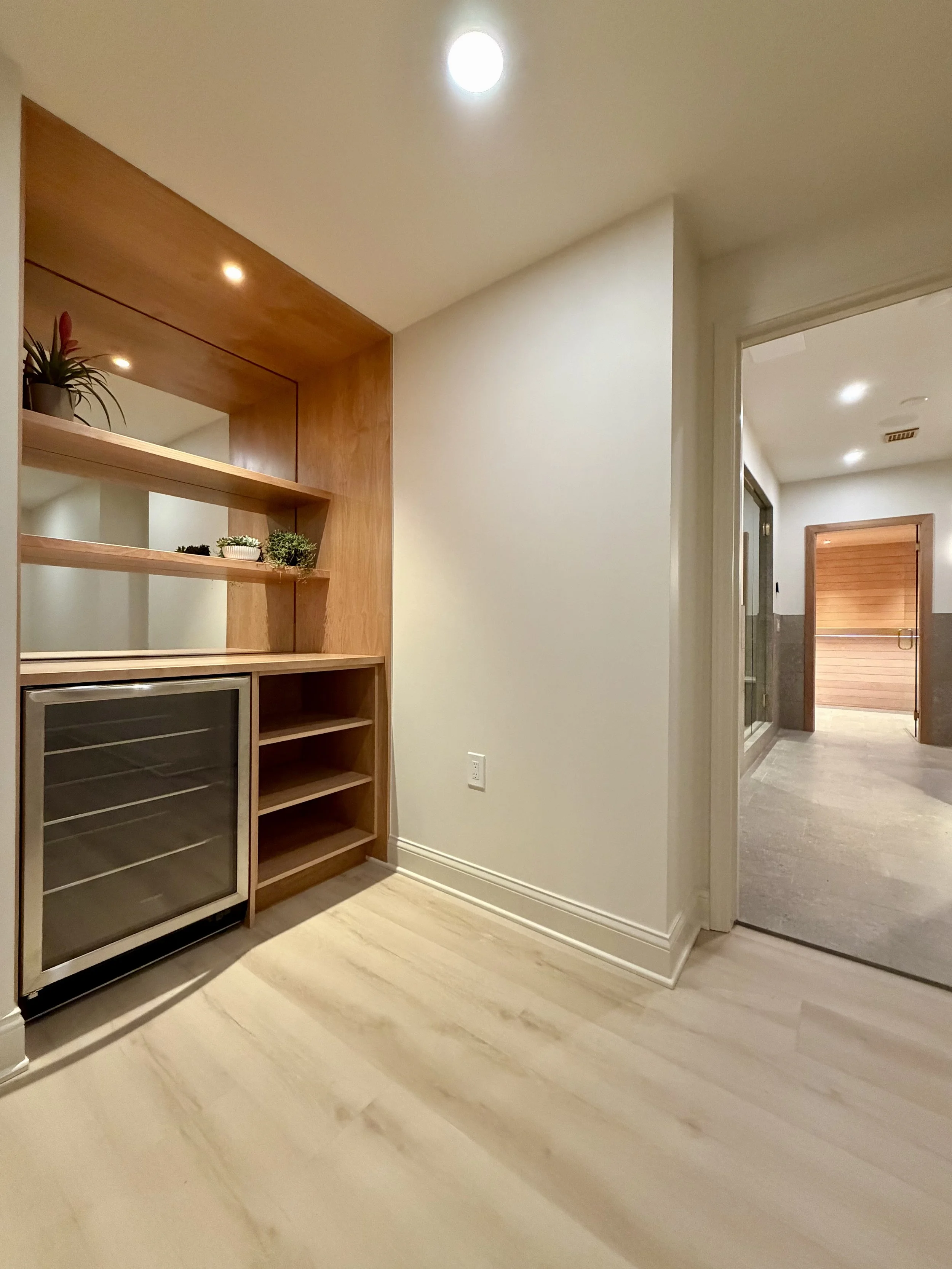 Foreground:

Custom Alcove in Alder with Beverage Center and 1/4" Mirror Backsplash.

Background:

Home Spa Project with Sauna, Steam Shower and Custom Millwork in Northville MI. 