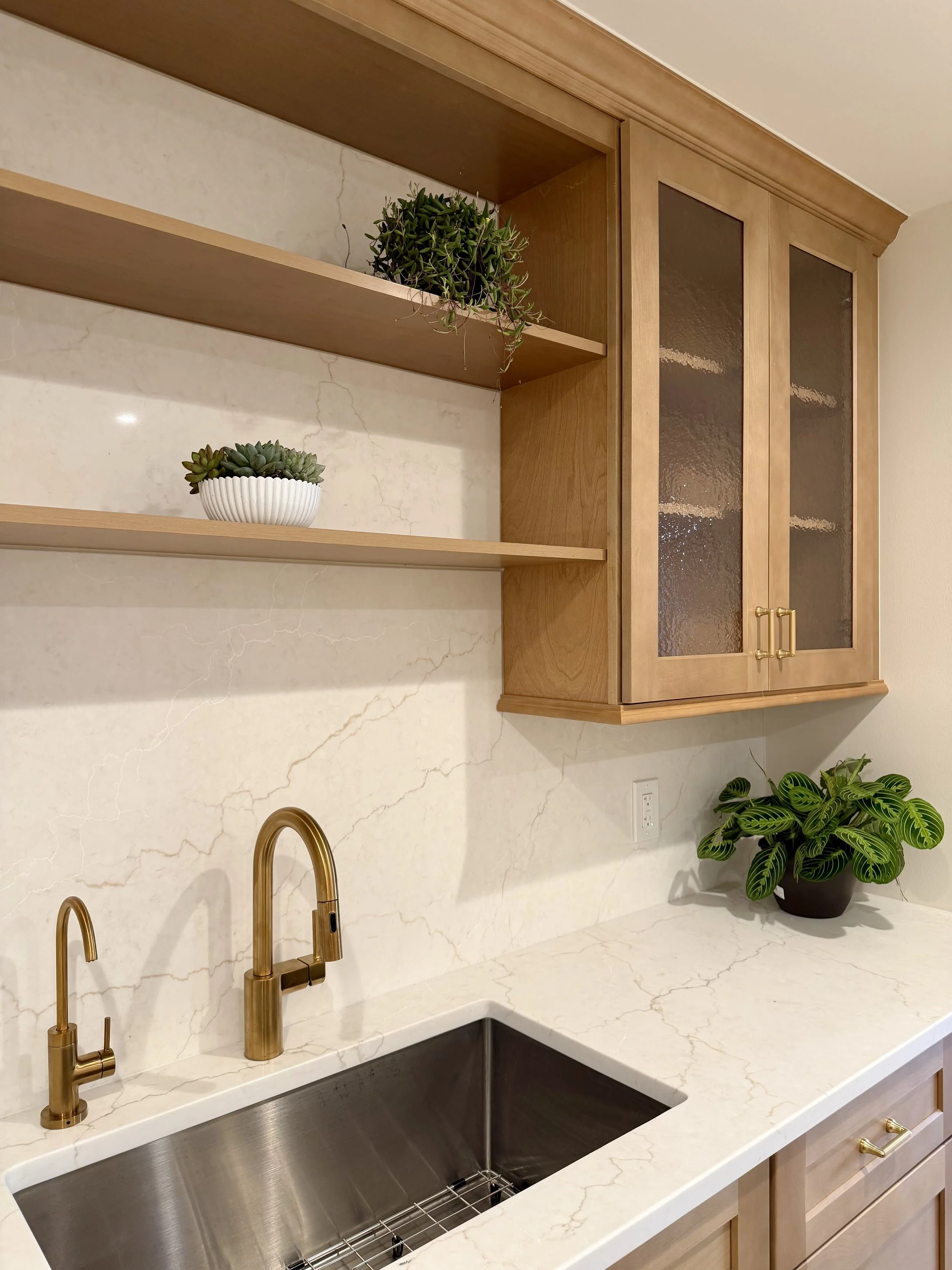 Architectural Details of Custom Built Wall Cabinets in White Oak with Hammered Cabinet Glass and Brushed Gold Hardware.

Plumbing Fixtures are Delta. 

Scandinavian Inspired Remodeling Project Completed in Northville MI. 