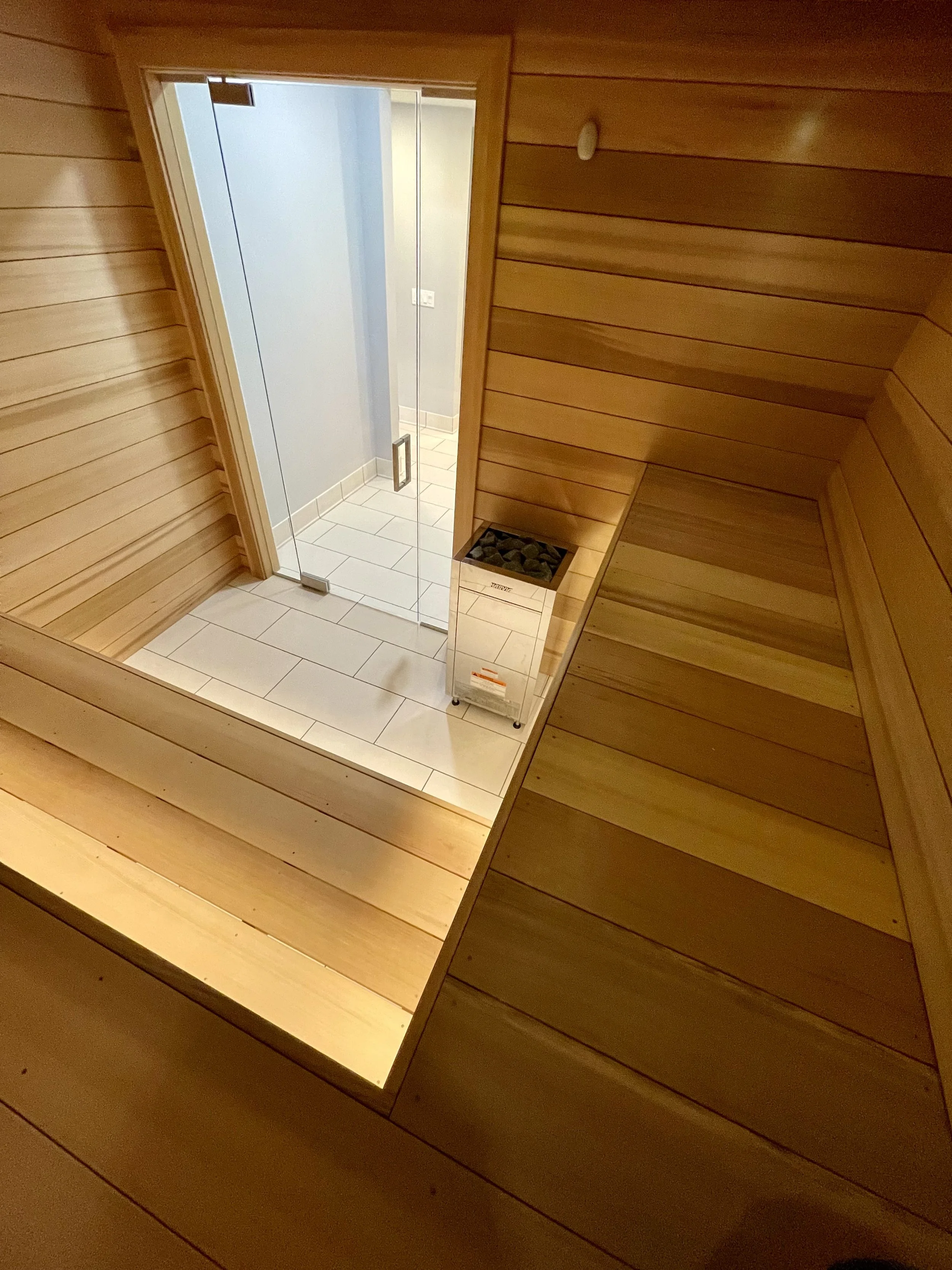 Architectural Details of Custom Built Sauna Using 3/4" X 5" Milled Tongue & Groove Cedar Hardwood and Linear Benches Reinforced with Steel. 

Under-mount Bench Lighting and Recessed Ceiling Lights Painted to Match.

Custom Sauna Door and Side-Lights 