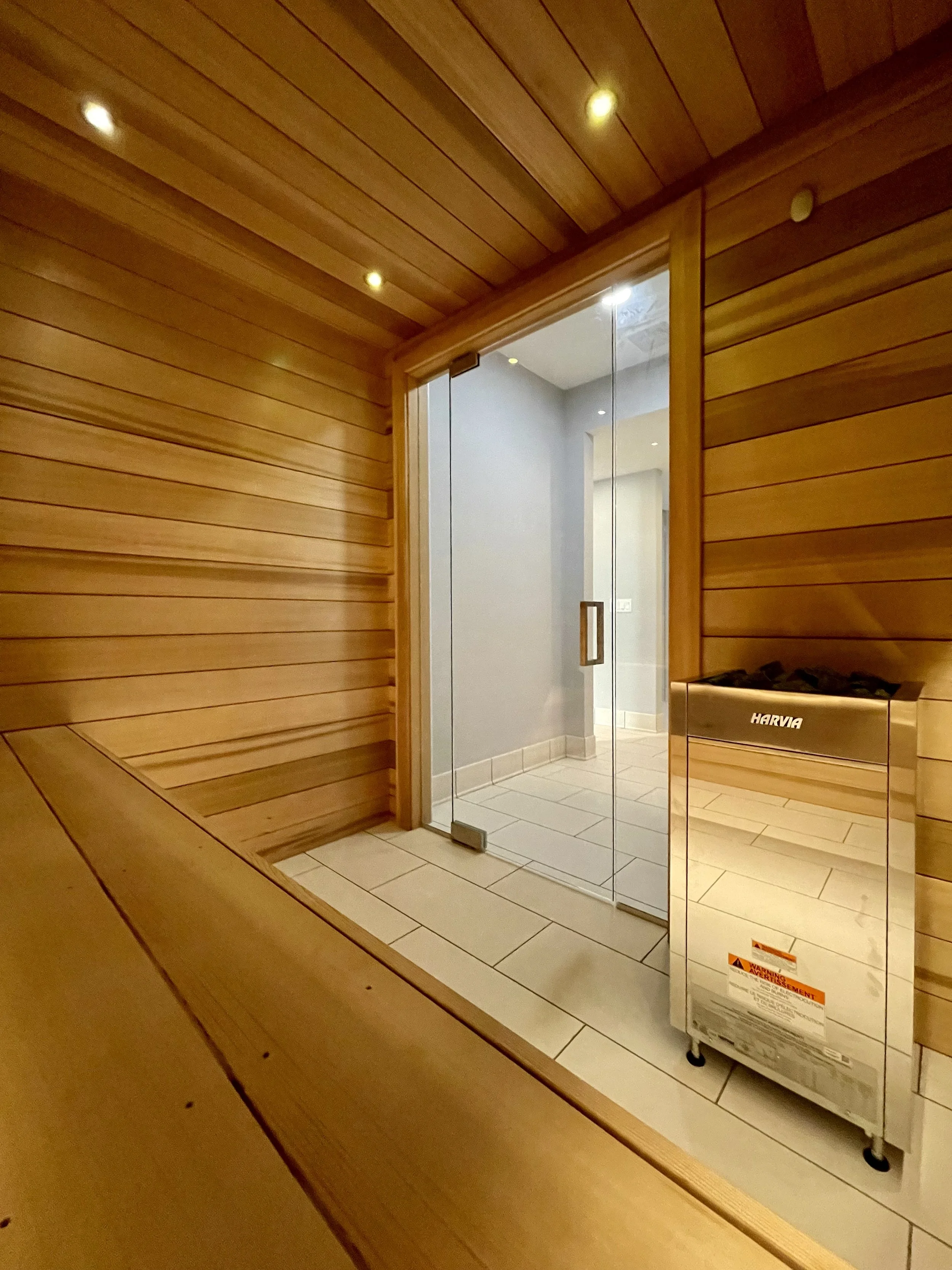 Architectural Details of Custom Built Sauna Using 3/4" X 5" Milled Tongue & Groove Cedar Hardwood and Linear Benches Reinforced with Steel. 

Under-mount Bench Lighting and Recessed Ceiling Lights Painted to Match.

Custom Sauna Door and Side-Lights 