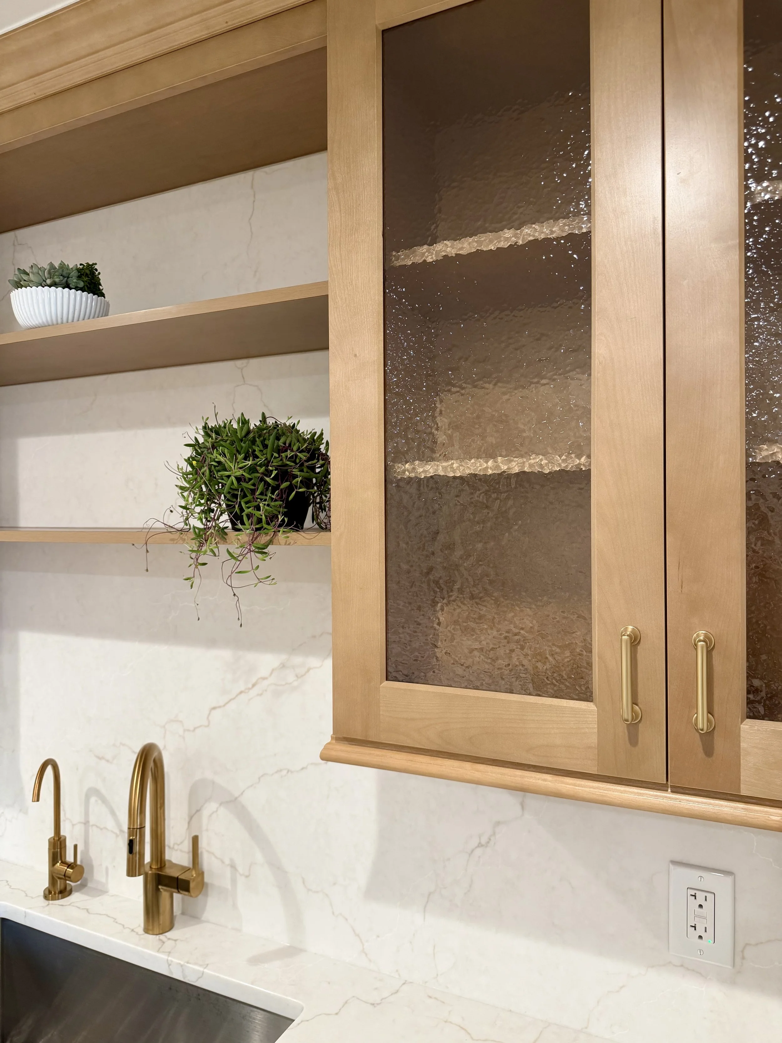 Architectural Details of Custom Built Wall Cabinets in White Oak with Hammered Cabinet Glass and Brushed Gold Hardware.

Plumbing Fixtures are Delta. 

Scandinavian Inspired Remodeling Project Completed in Northville MI. 