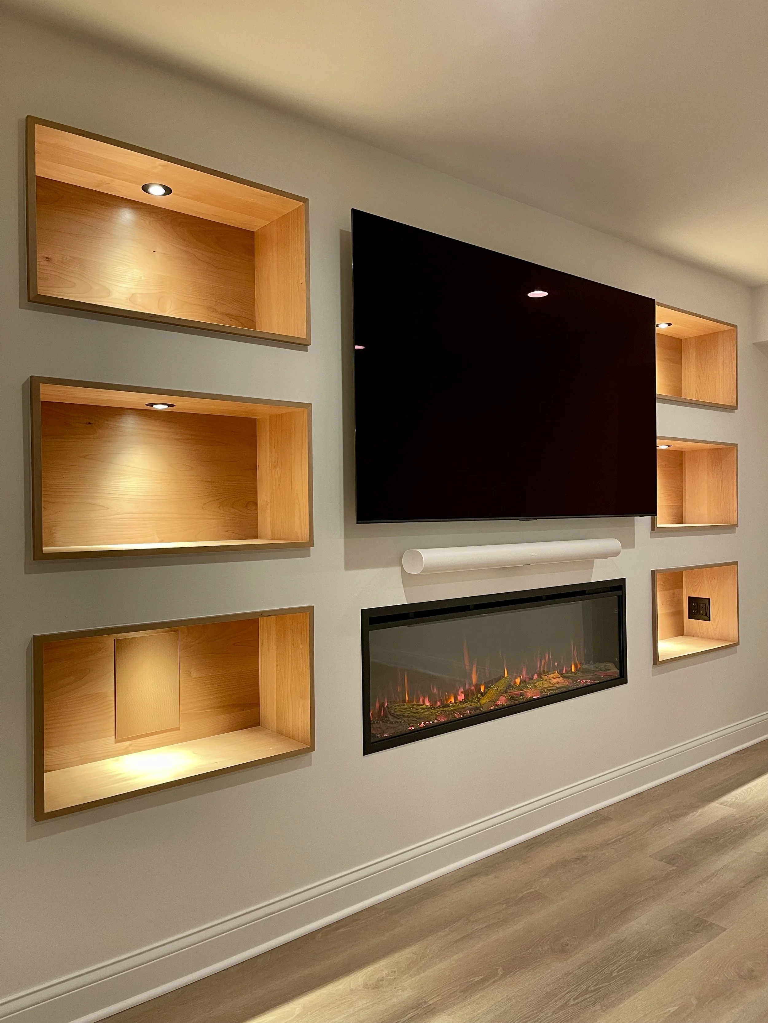 Alder Shelving with Linear Fireplace in the Sitting Area as Part of a Larger Custom Wine Cellar Project Completed in Northville MI. 