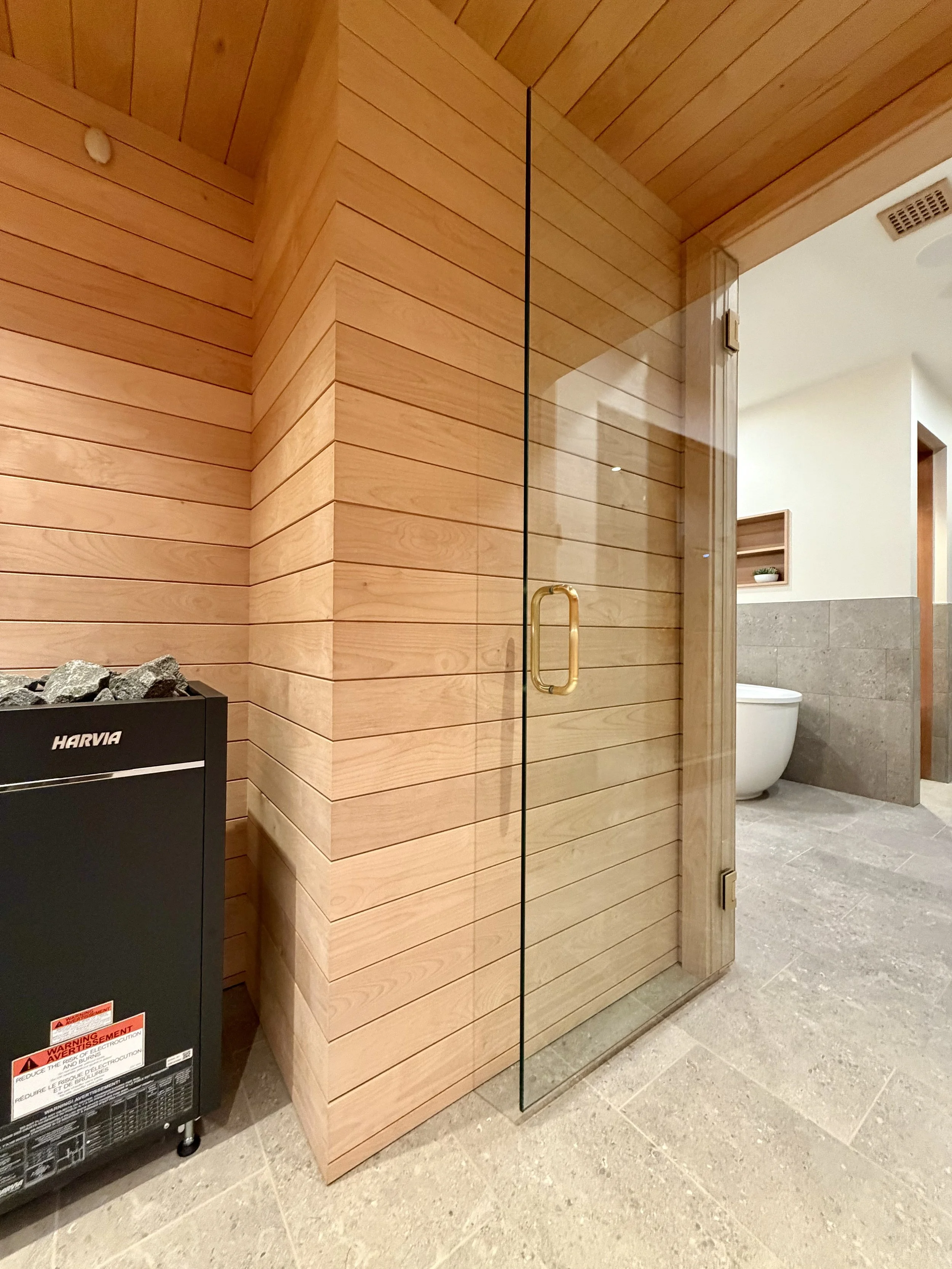 Architectural Details of Custom Built Sauna Using 3/4" X 4" Milled Tongue & Groove Alder Hardwood and Linear Benches Reinforced with Steel. 

Under-mount Bench Lighting and Recessed Ceiling Lights Painted to Match.

Custom Sauna Door in 1/2" Clear Gl