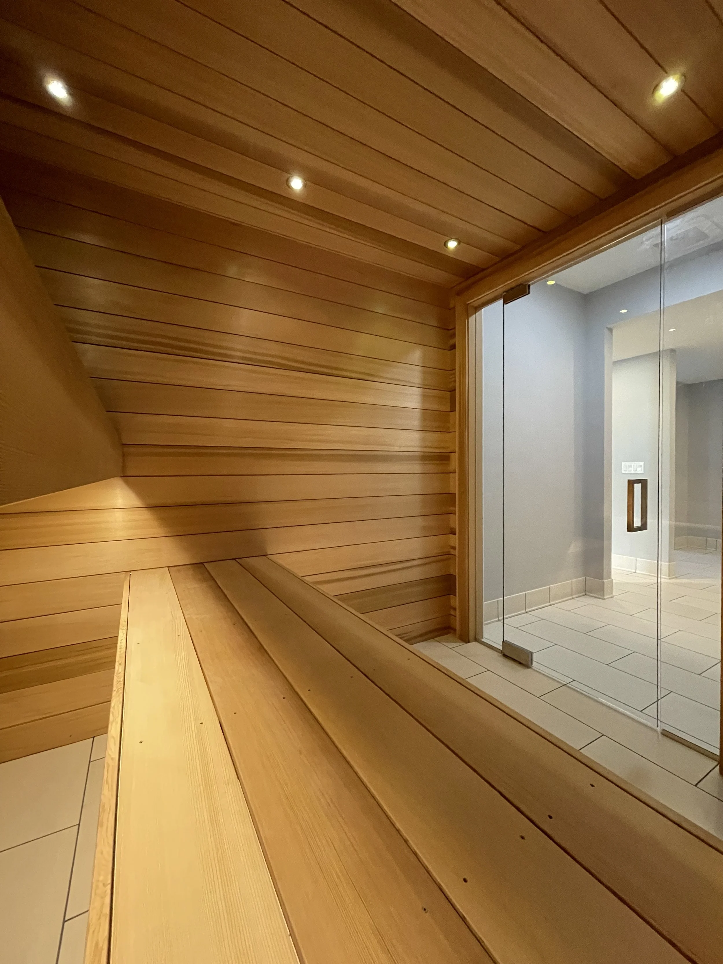 Architectural Details of Custom Built Sauna Using 3/4" X 5" Milled Tongue & Groove Cedar Hardwood and Linear Benches Reinforced with Steel. 

Under-mount Bench Lighting and Recessed Ceiling Lights Painted to Match.

Custom Sauna Door and Side-Lights 