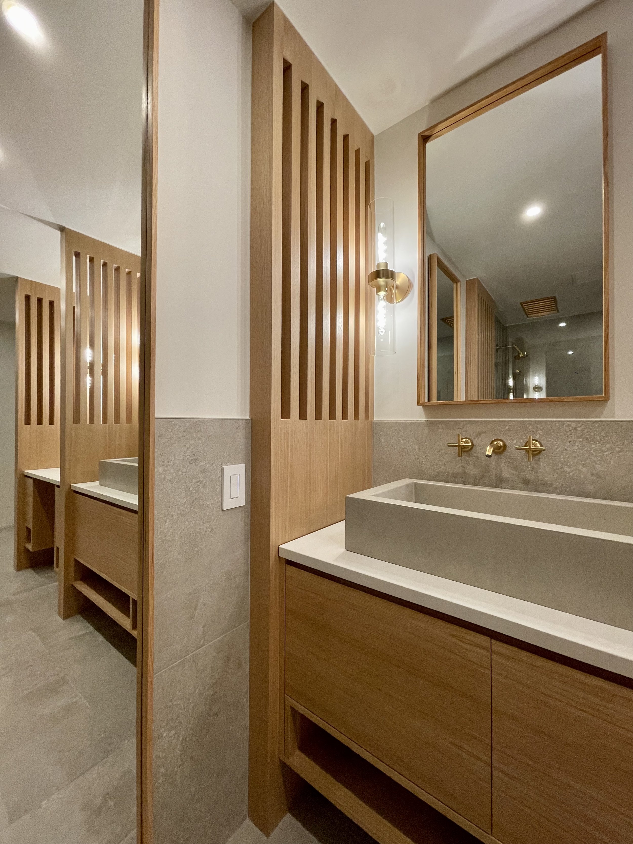 Architectural Details in Uniform Hickory Veneer and Hickory Heartwood Finished with Centurion 2K Polyurethane.

Wall Mounted Fixtures are Kohler Purist in Vibrant Brushed Modern Gold. 

TrueForm Custom Concrete Sink in Taupe

Scandinavian Inspired Ba