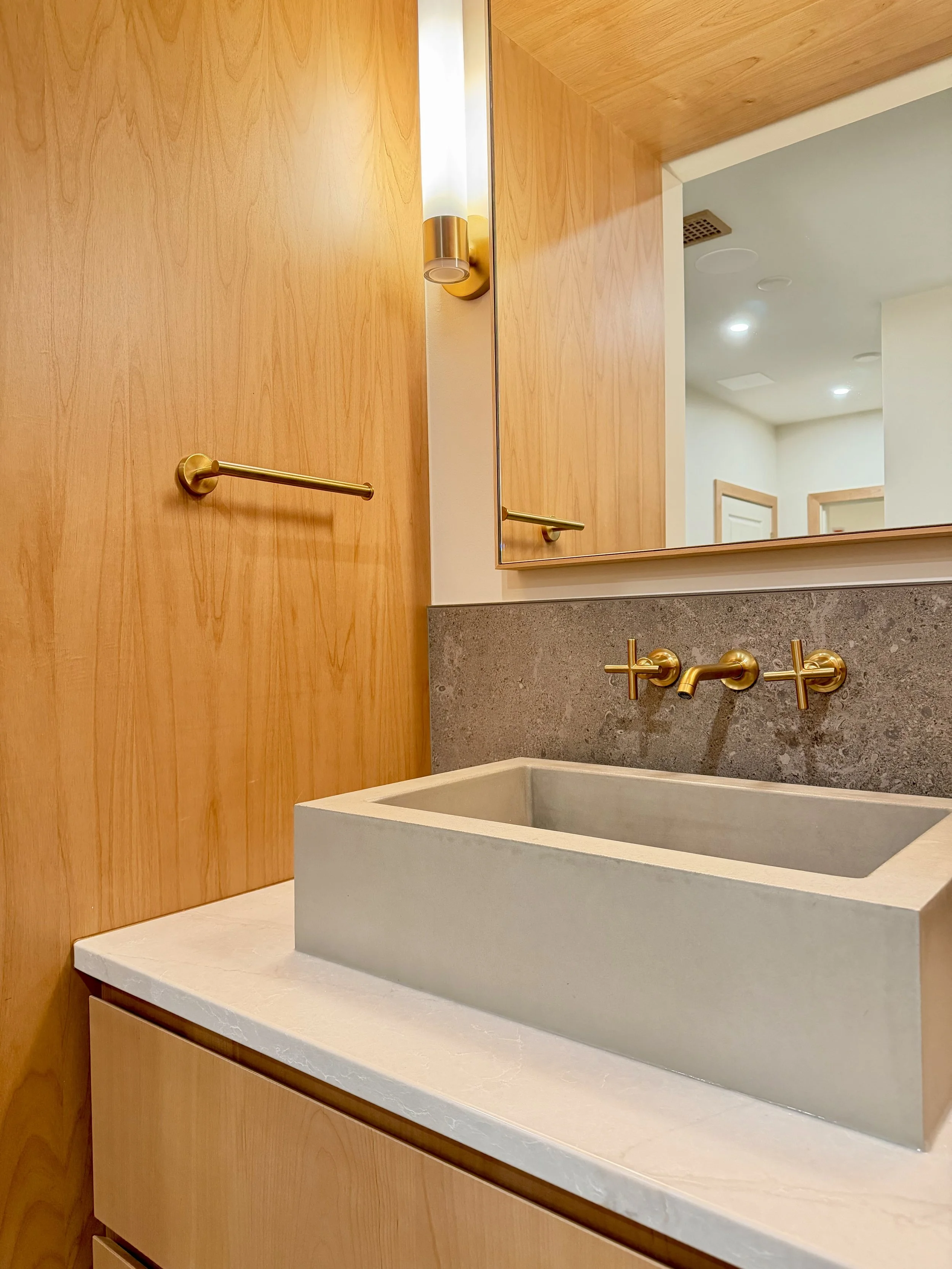 Custom Built Linear Floating Vanity in Uniform Clear Alder Veneer and Alder Hardwoods. Perimeter is Wrapped in 3/4" Edge-banded Alder Plywood Finished with Centurion 2K Polyurethane. 

Electrical & Wall Mounter Plumbing Fixtures are Kohler Purist in 