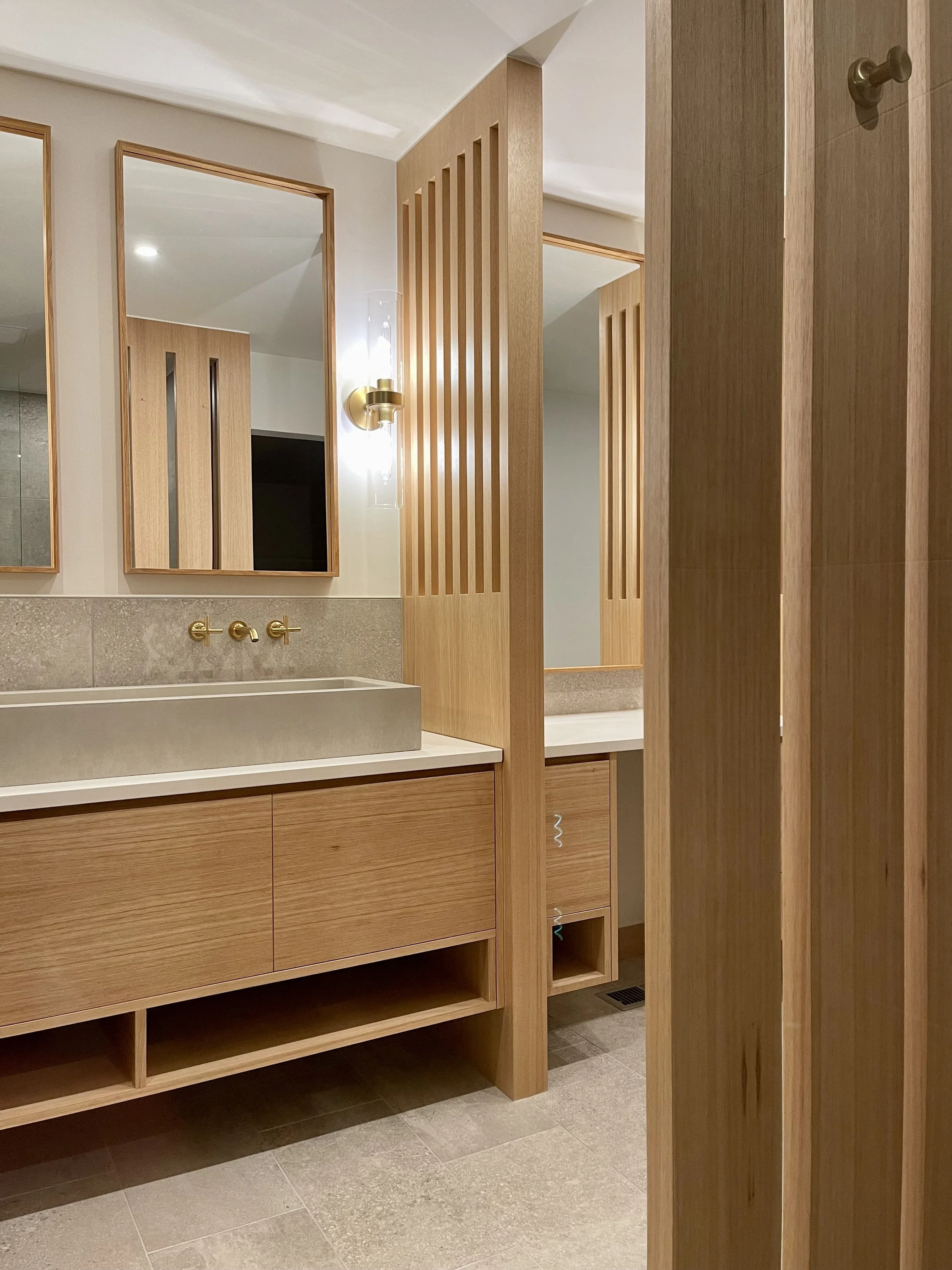 Architectural Details in Uniform Hickory Veneer and Hickory Heartwood Finished with Centurion 2K Polyurethane.

Wall Mounted Fixtures are Kohler Purist in Vibrant Brushed Modern Gold. 

TrueForm Custom Concrete Sink in Taupe

Scandinavian Inspired Ba