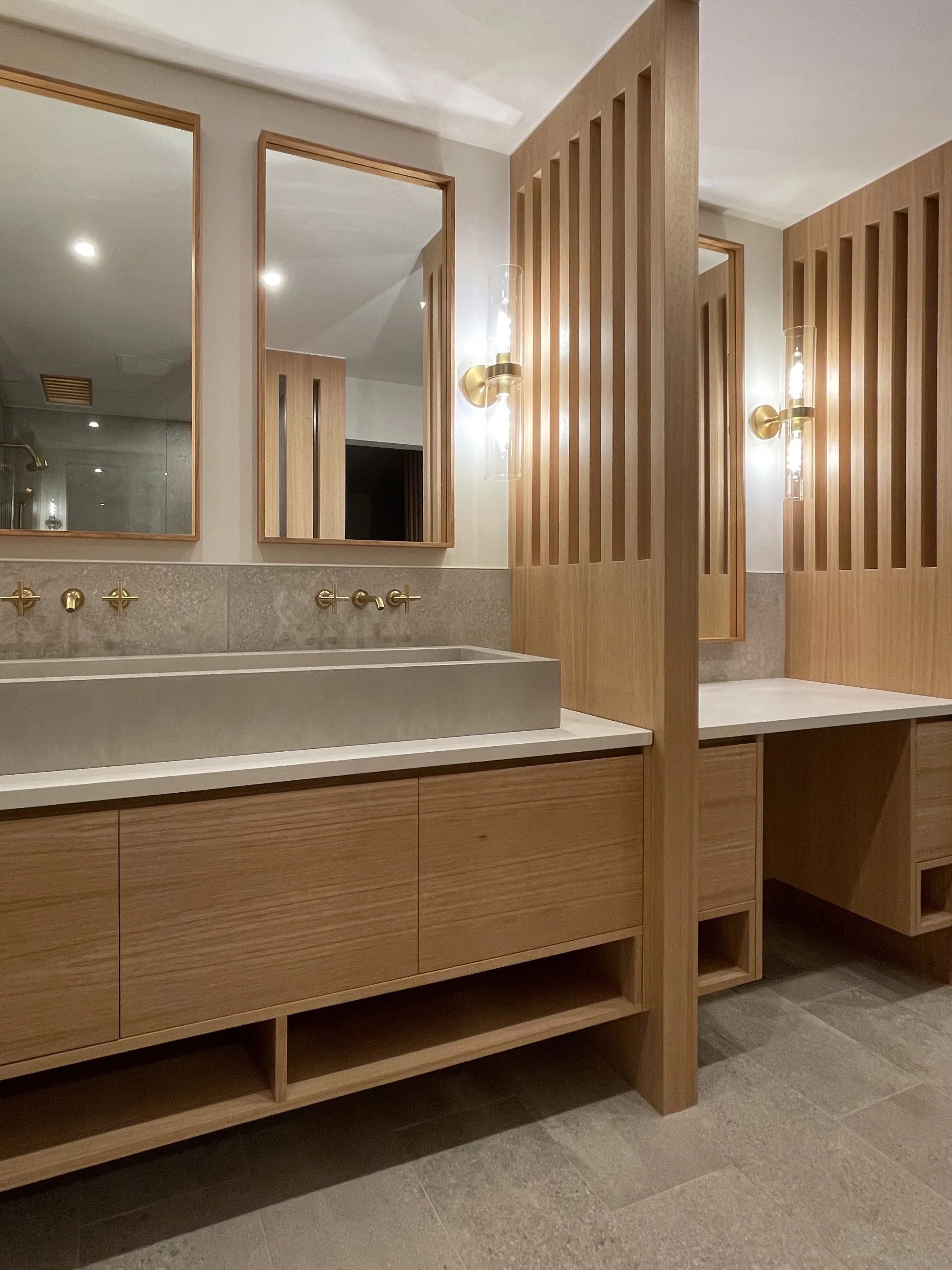 Architectural Details in Uniform Hickory Veneer and Hickory Heartwood Finished with Centurion 2K Polyurethane.

Wall Mounted Fixtures are Kohler Purist in Vibrant Brushed Modern Gold. 

TrueForm Custom Concrete Sink in Taupe

Scandinavian Inspired Ba