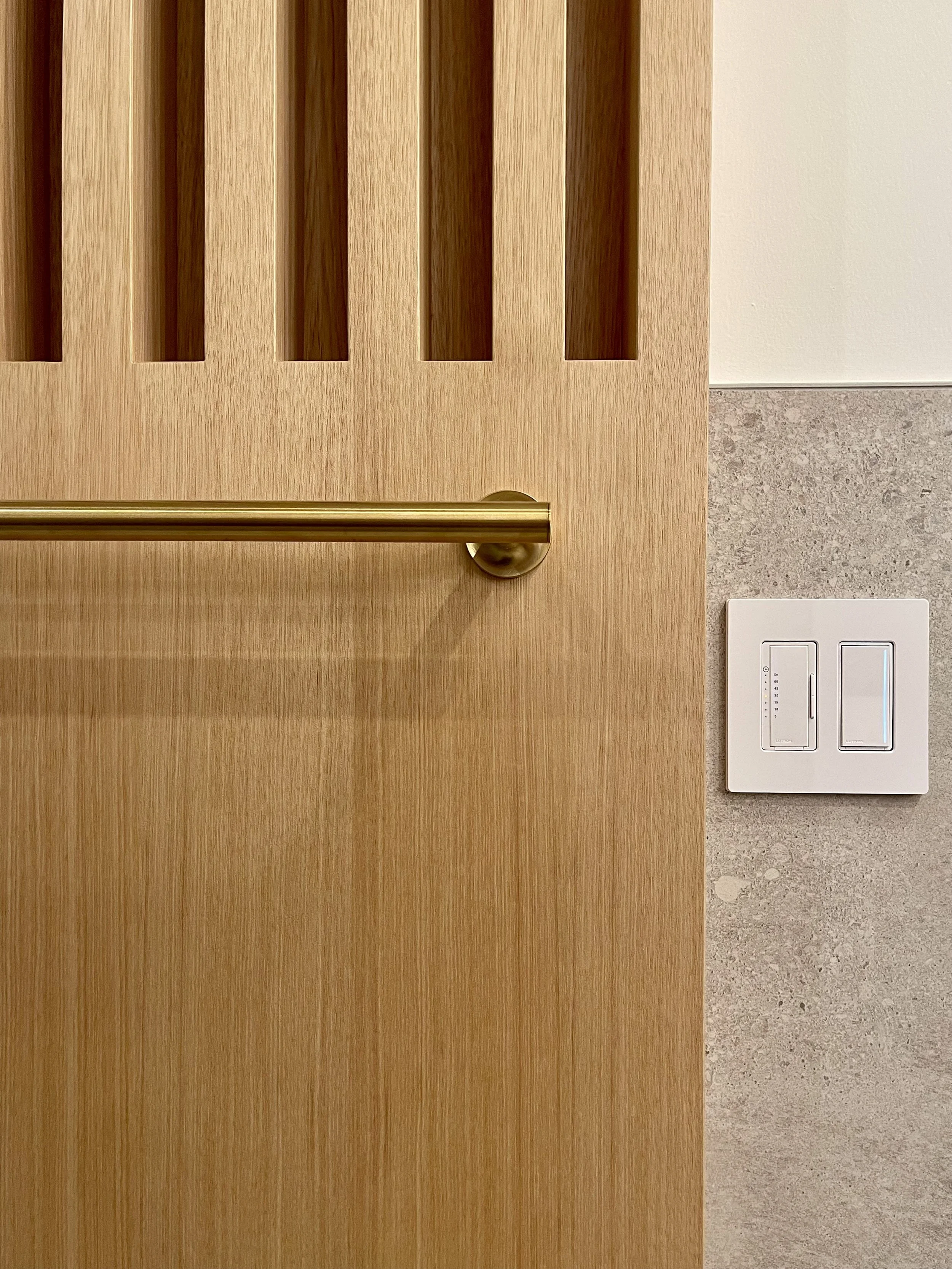 Architectural Detail in Uniform Hickory Veneer  Finished with Centurion 2K Polyurethane.

Wall Mounted Fixture is Kohler Purist in Vibrant Brushed Modern Gold. 

Bathroom Remodeling and Design Project Completed in Northville MI