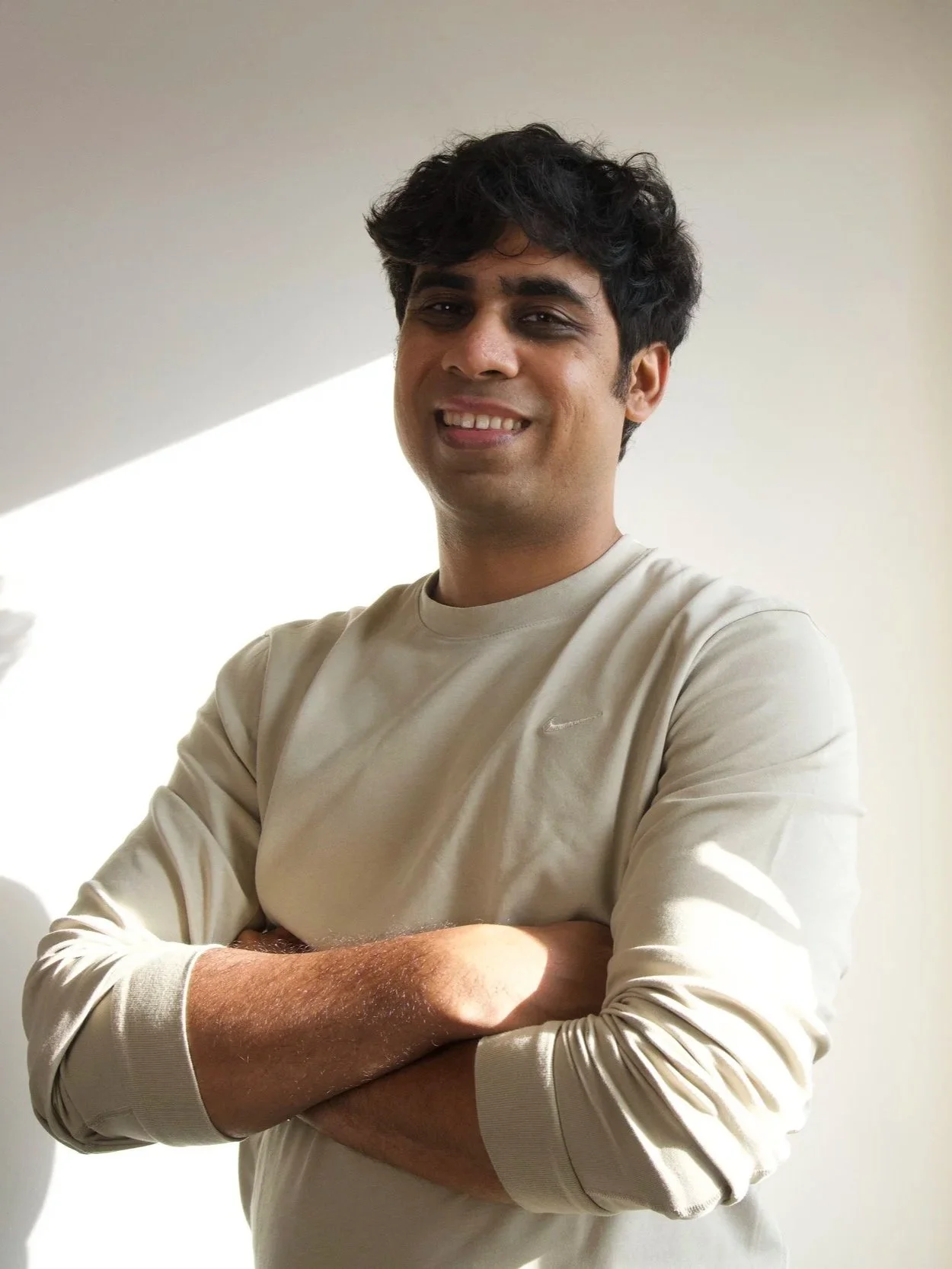 Personal trainer Chirag Chordia smiling with arms crossed against a light background in Chennai.