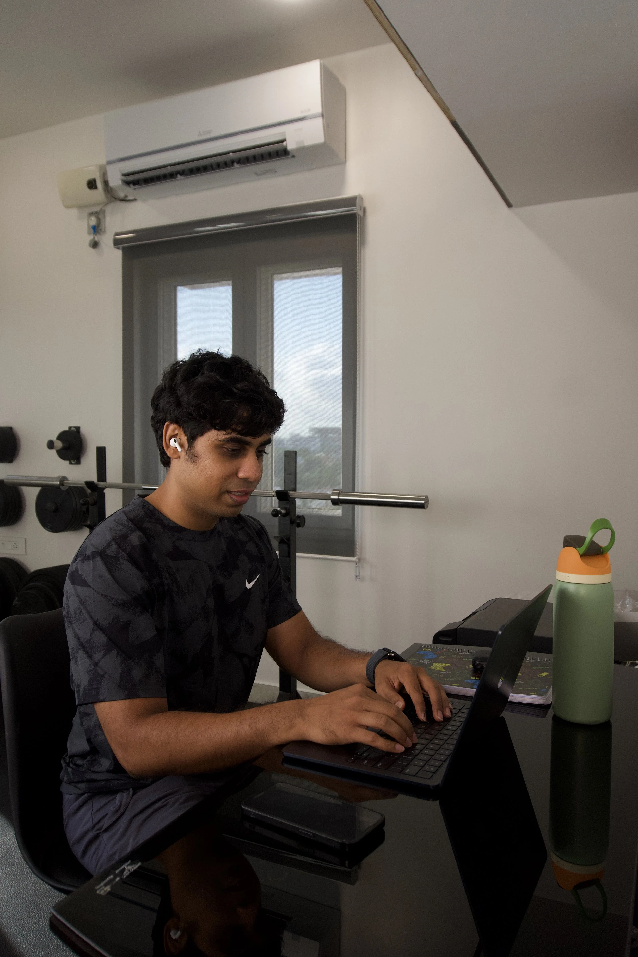 Online fitness coach Chirag Chordia designing individualized workout programs on his laptop.