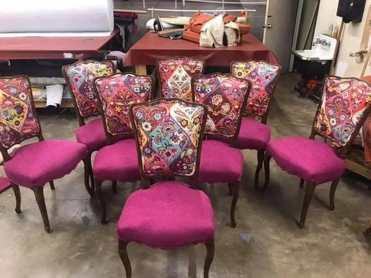 A set of dining chairs in bold custom fabric, finished in the workshop