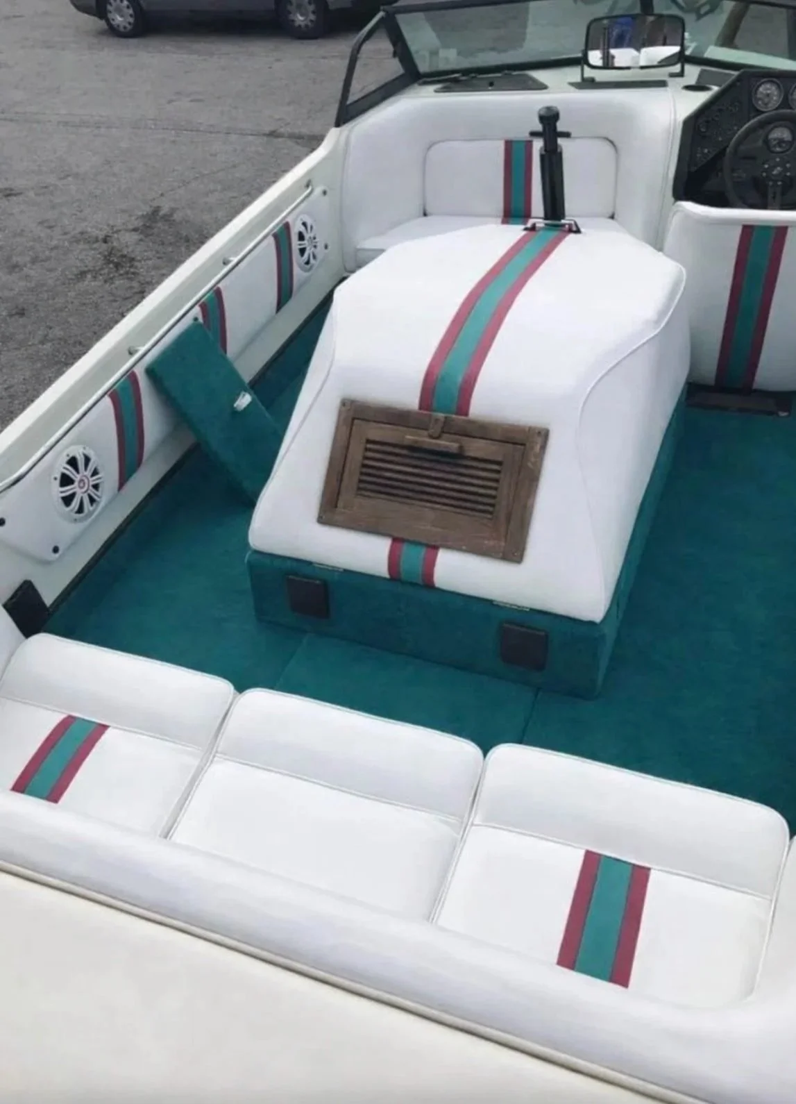 A boat interior reupholstered with white seating and striped detailing