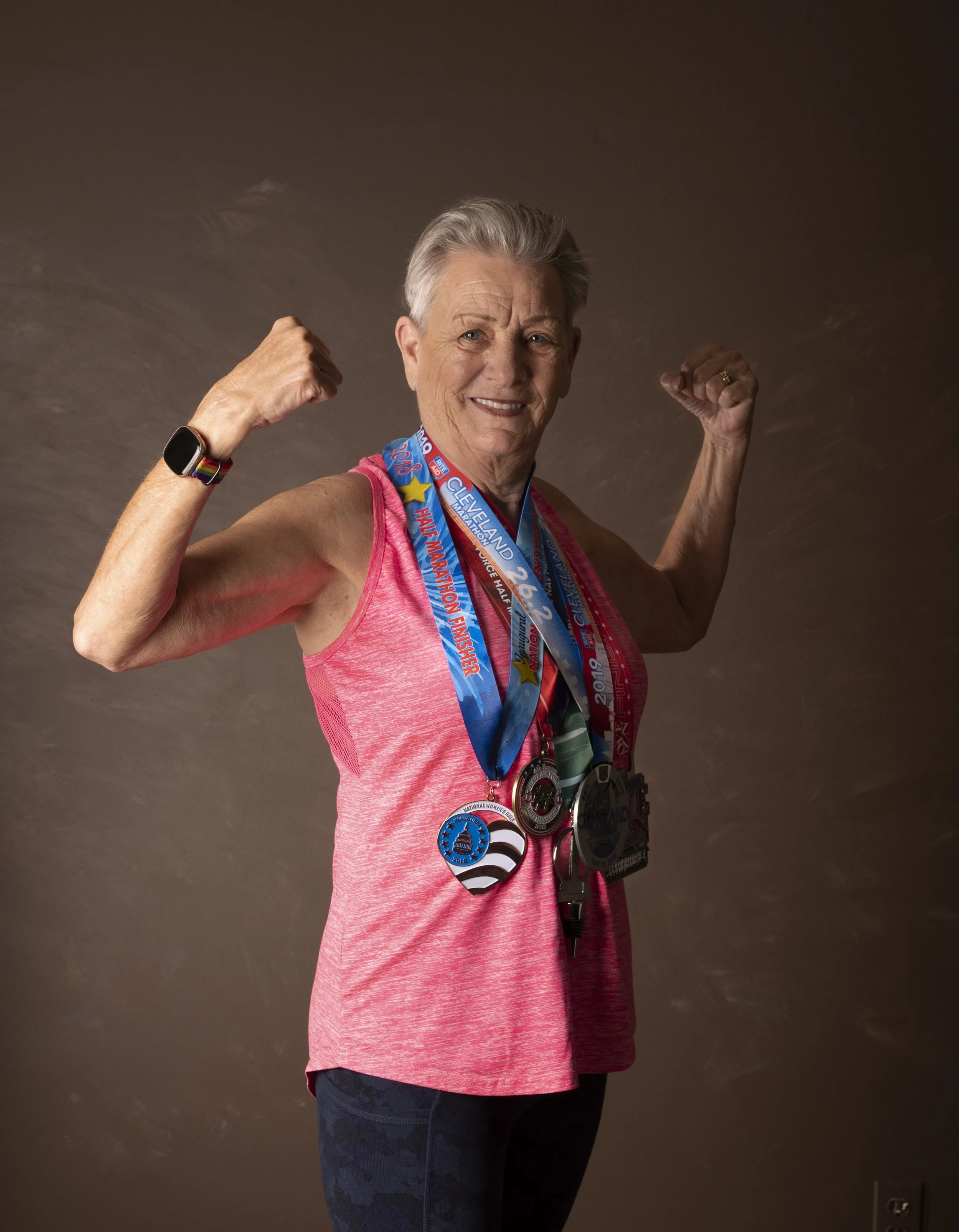 82 year old woman with running medals