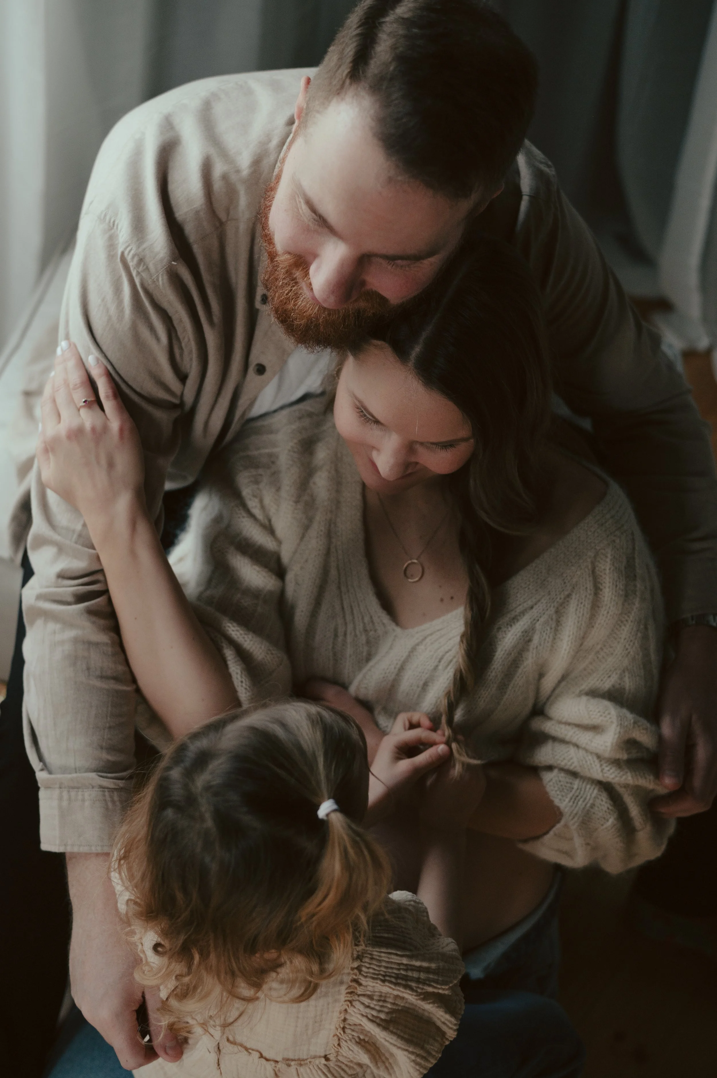 Perhe halimassa ja halaamassa sisällä, lämmin ja intiimi hetki.