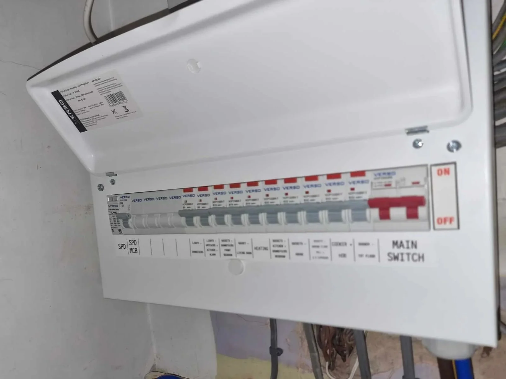Electrical circuit breaker box with the door open, showing multiple circuit breakers inside.