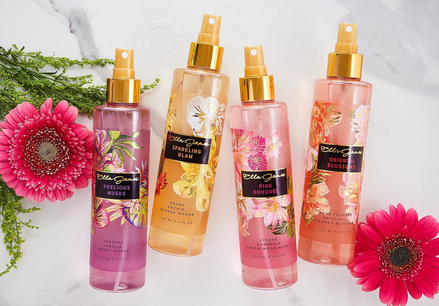 Ella James elegant women’s perfume bottles displayed together with flowers and green plants