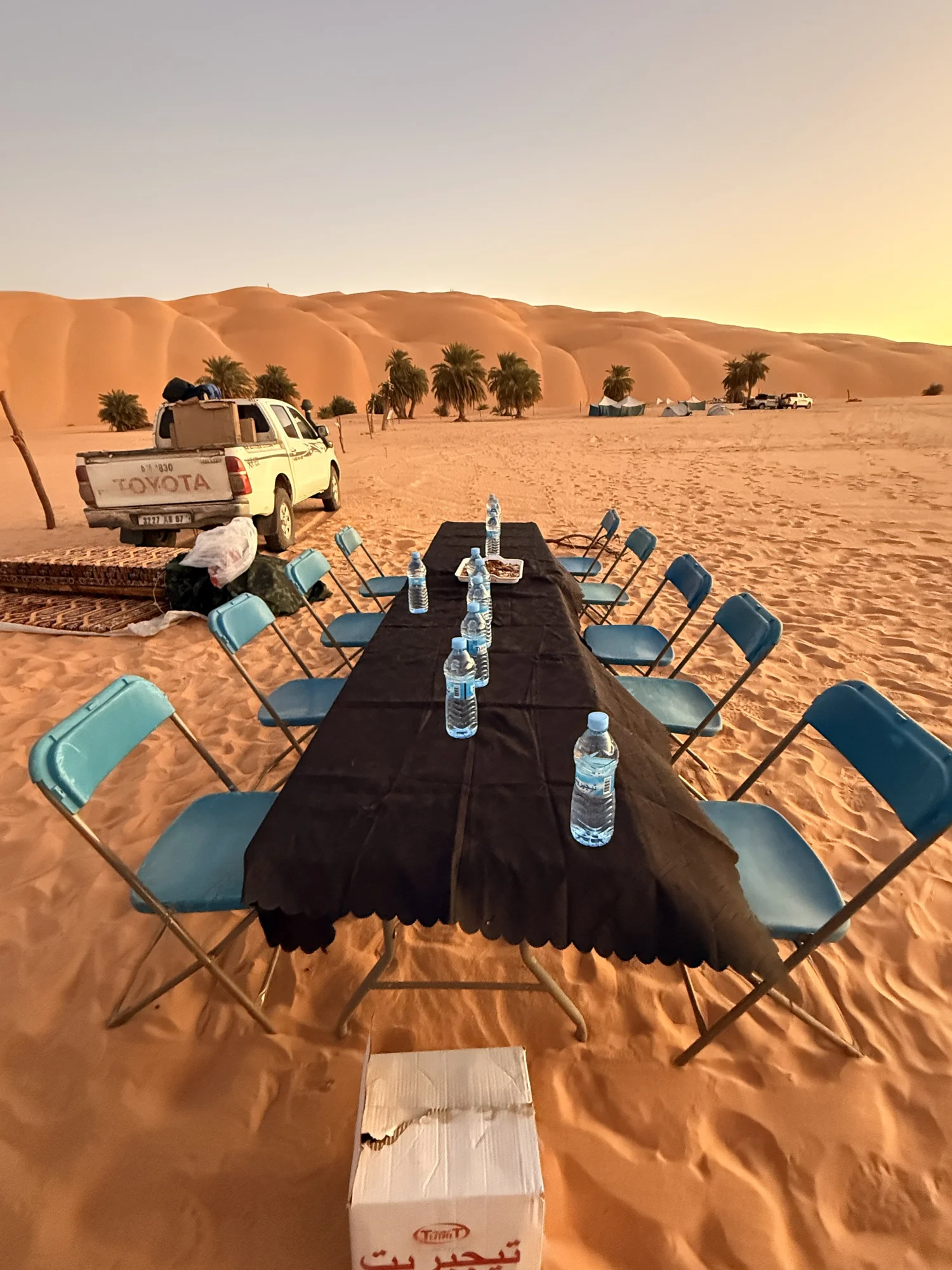 Dinner set out in the dunes at sunset