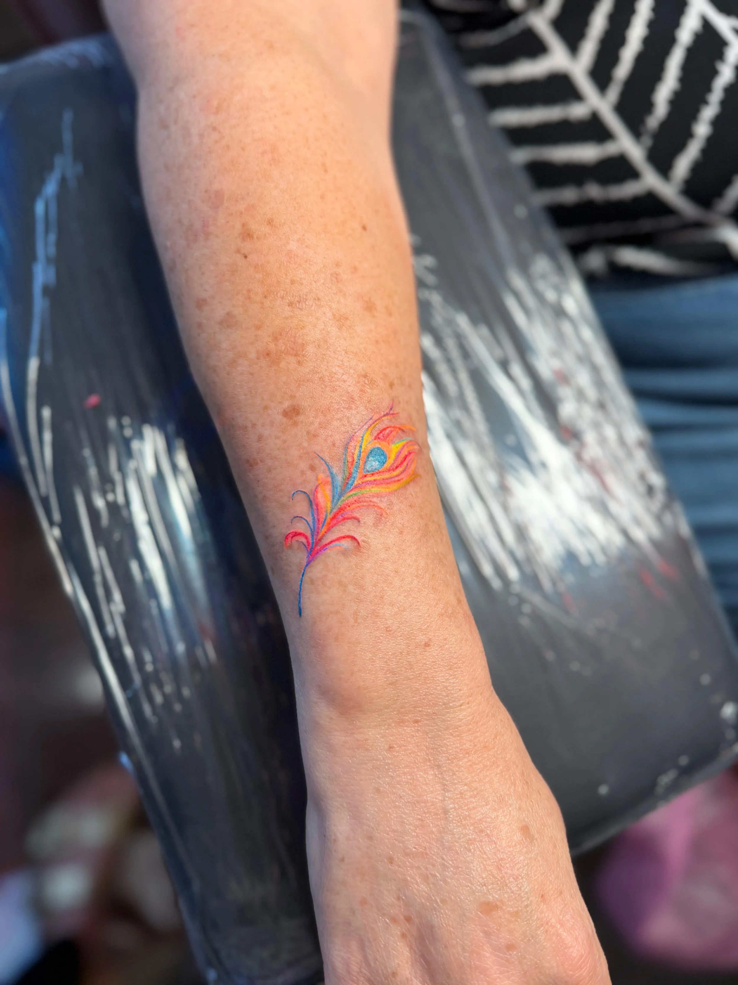 tb feather tattoo.jpg